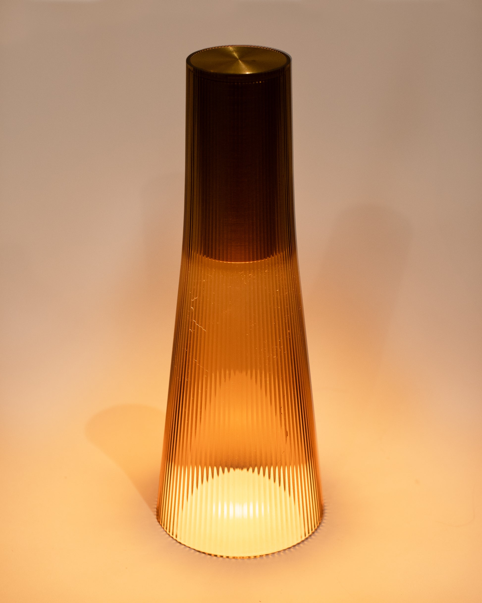 A rechargeable flared table lamp in a bronze color way.