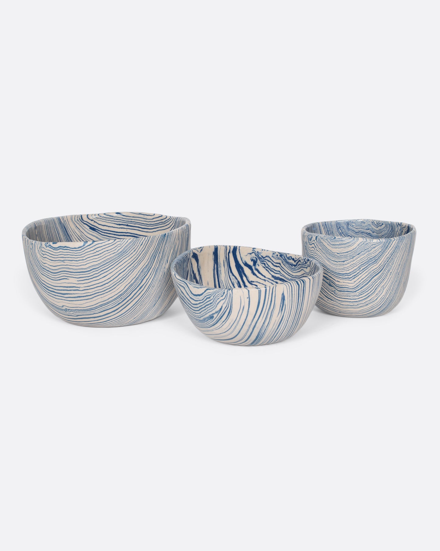 These small batch ceramic bowls look plucked straight from the ocean, with flowing hues of blue and white. They're made with a traditional Japanese Nerikomi technique that creates an intricate, marbled design by layering and compressing clay. Available in small, medium, and large sizes.