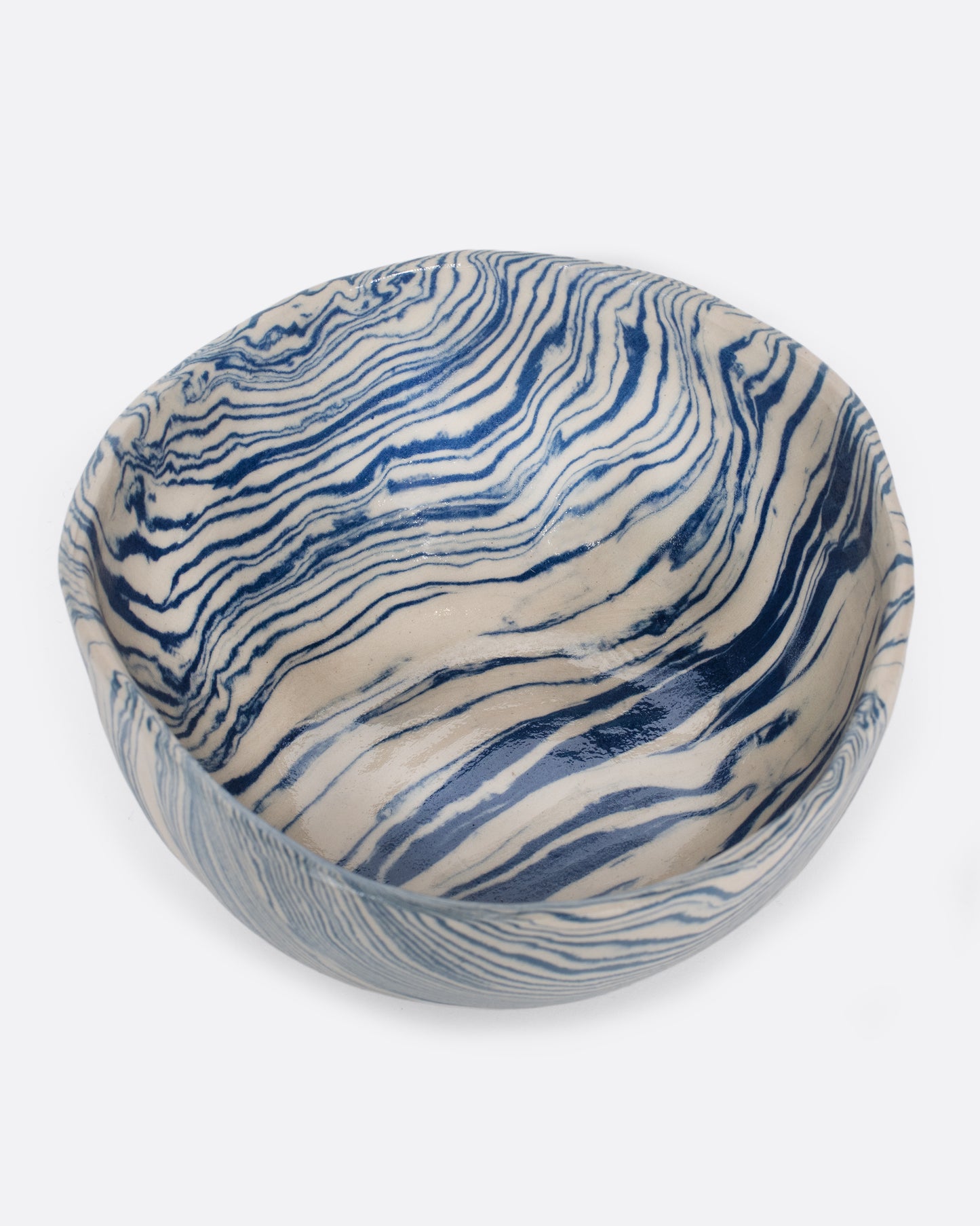 These small batch ceramic bowls look plucked straight from the ocean, with flowing hues of blue and white. They're made with a traditional Japanese Nerikomi technique that creates an intricate, marbled design by layering and compressing clay. Available in small, medium, and large sizes.