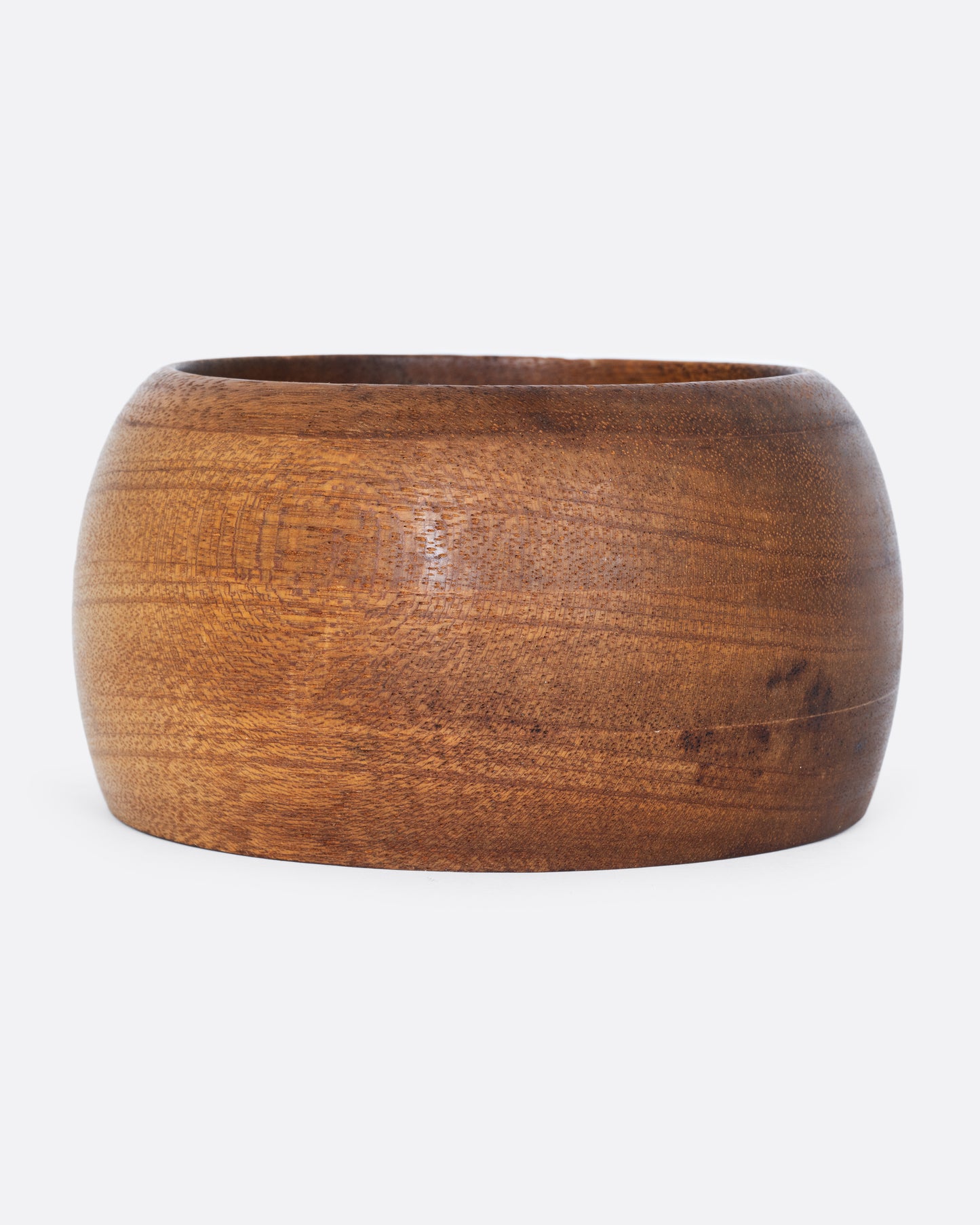 A wooden bowl shown from the side.