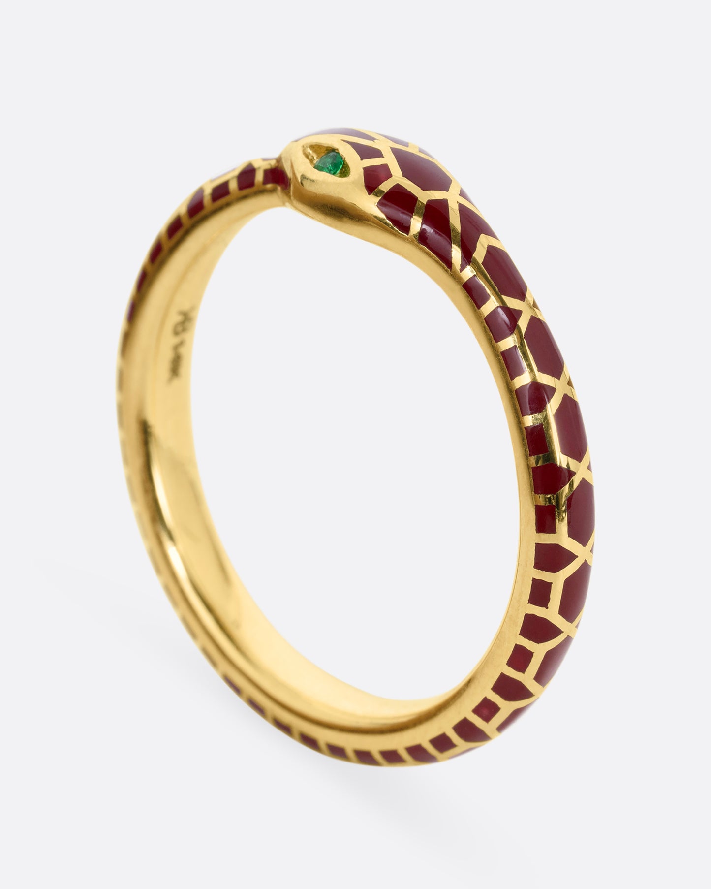 yellow gold ring with emerald and enamel shown from the side