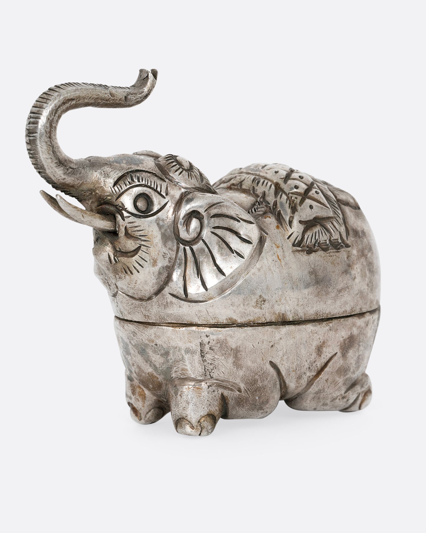 A silver elephant shaped box shown from the side.