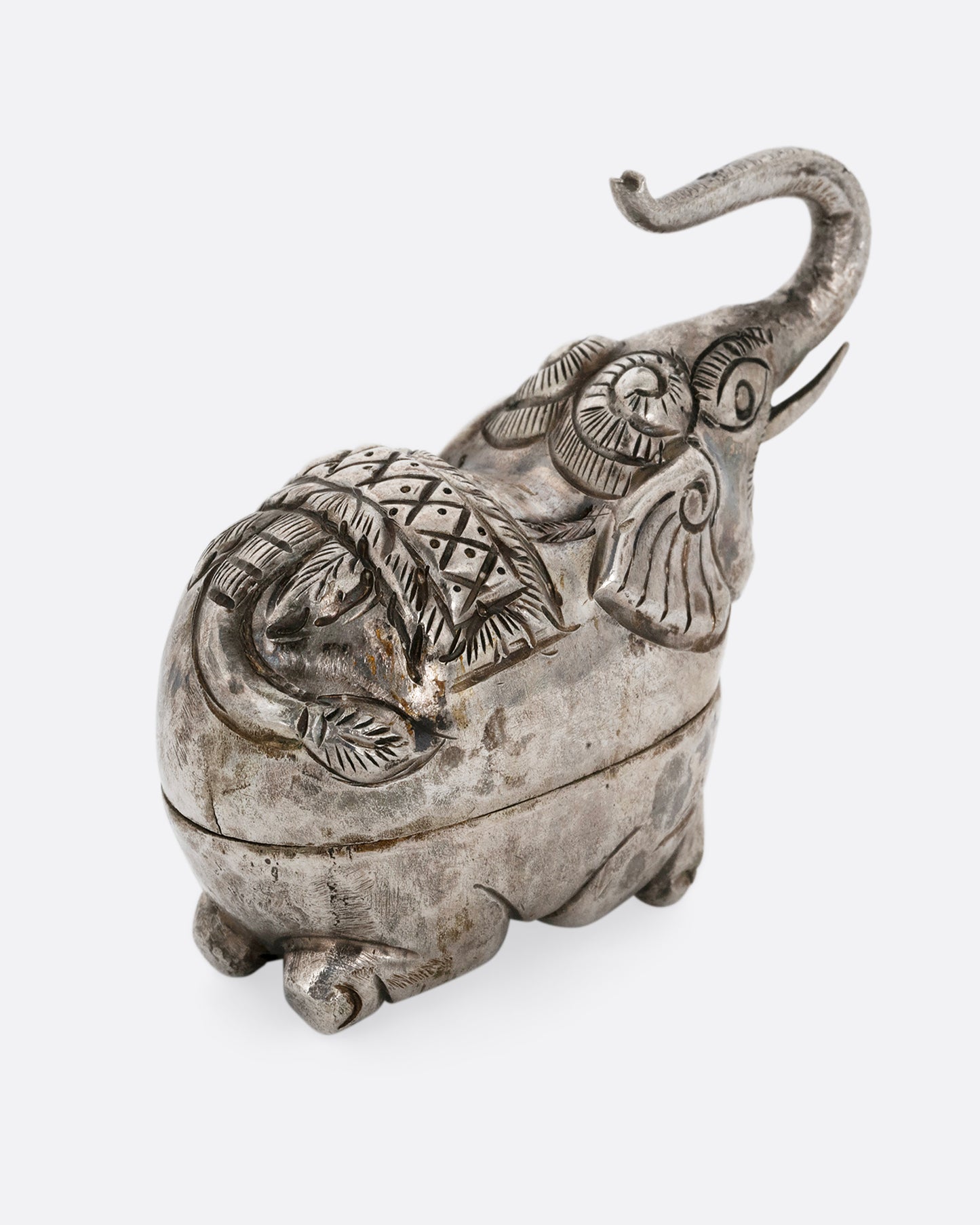 A silver elephant shaped box shown from the back.