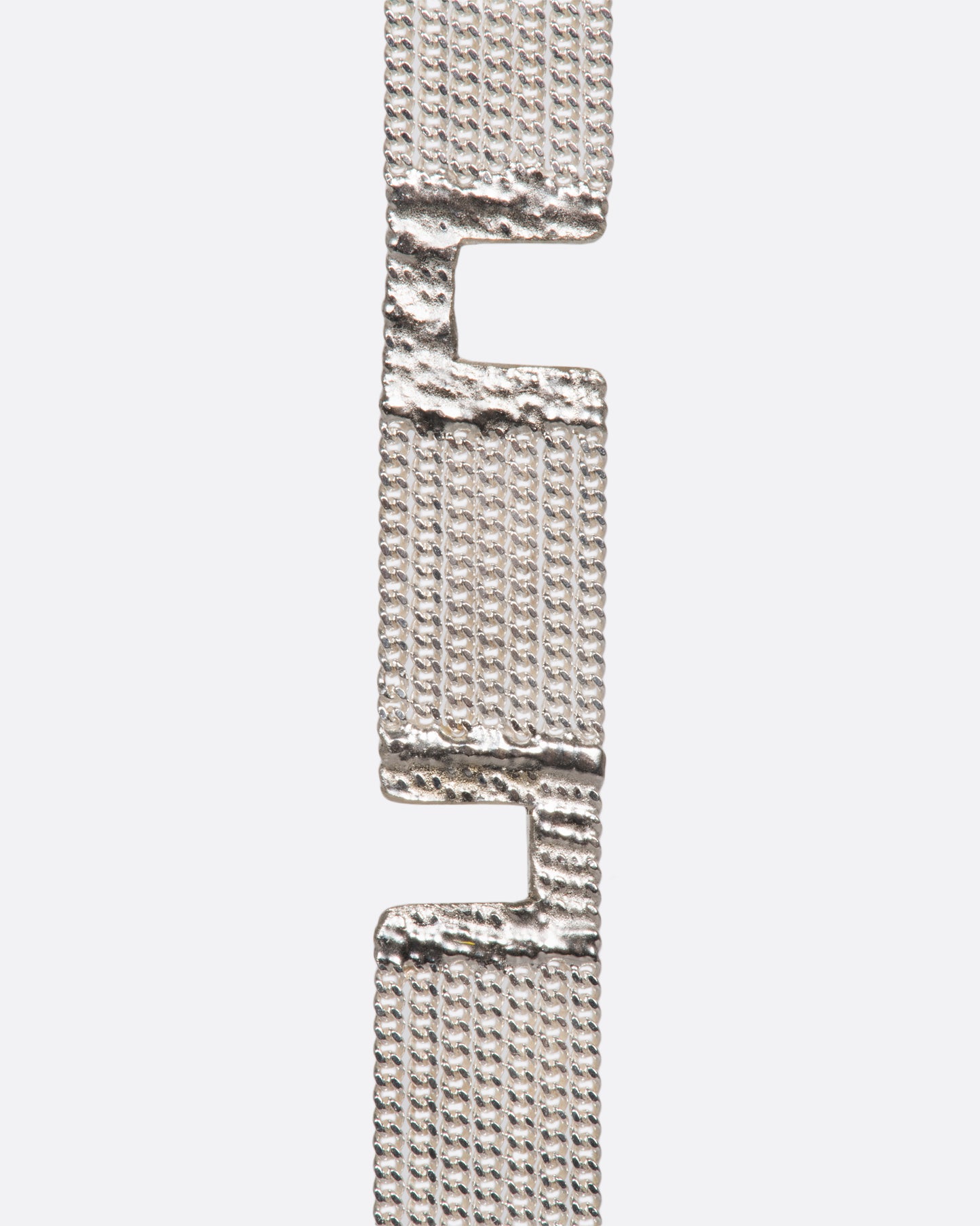 A sterling silver multi-strand chain bracelet with alternating pattern finished with silver solder.