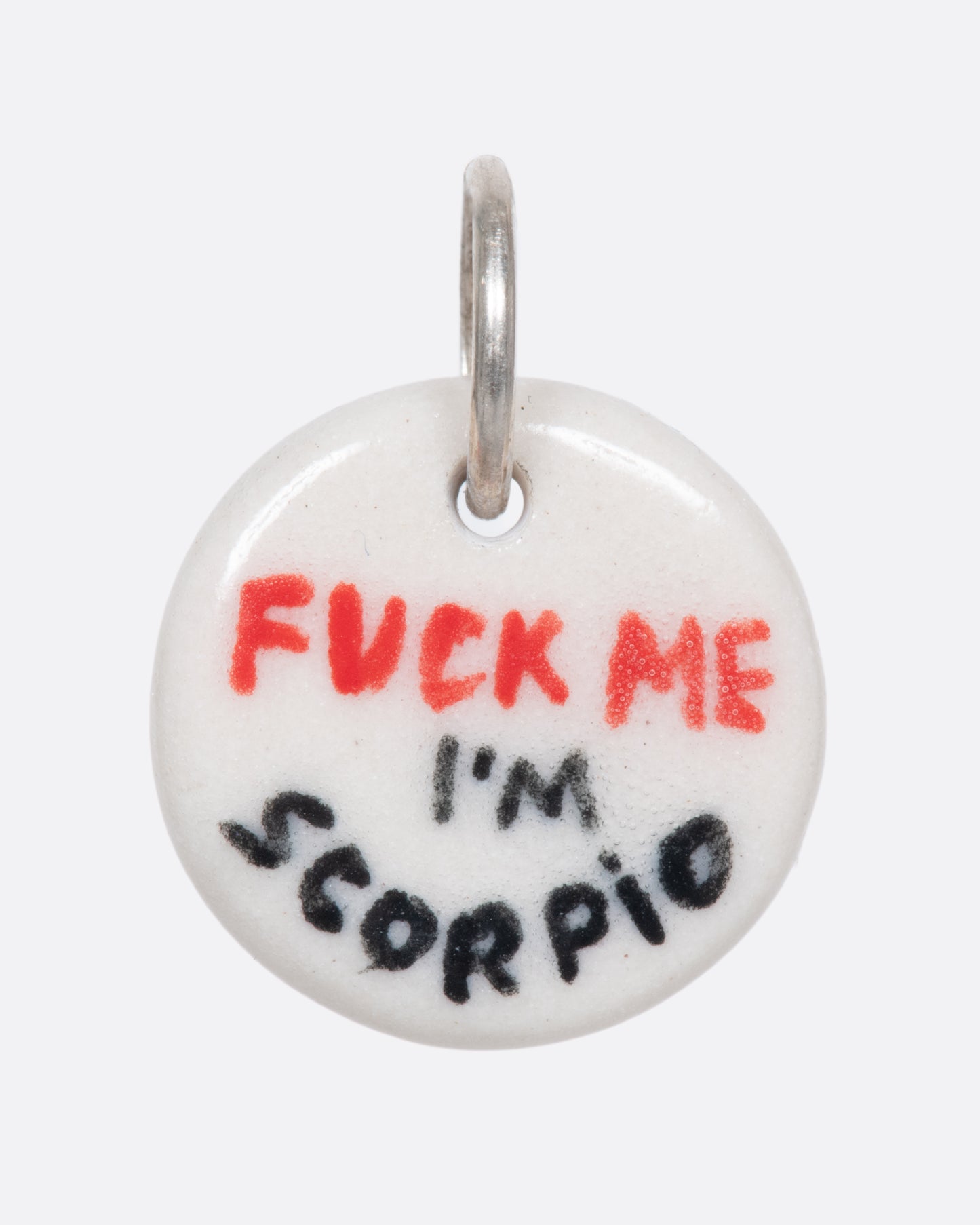 A handmade and painted porcelain zodiac disc charm with a sterling silver bail, featuring a sex position specific to each zodiac.