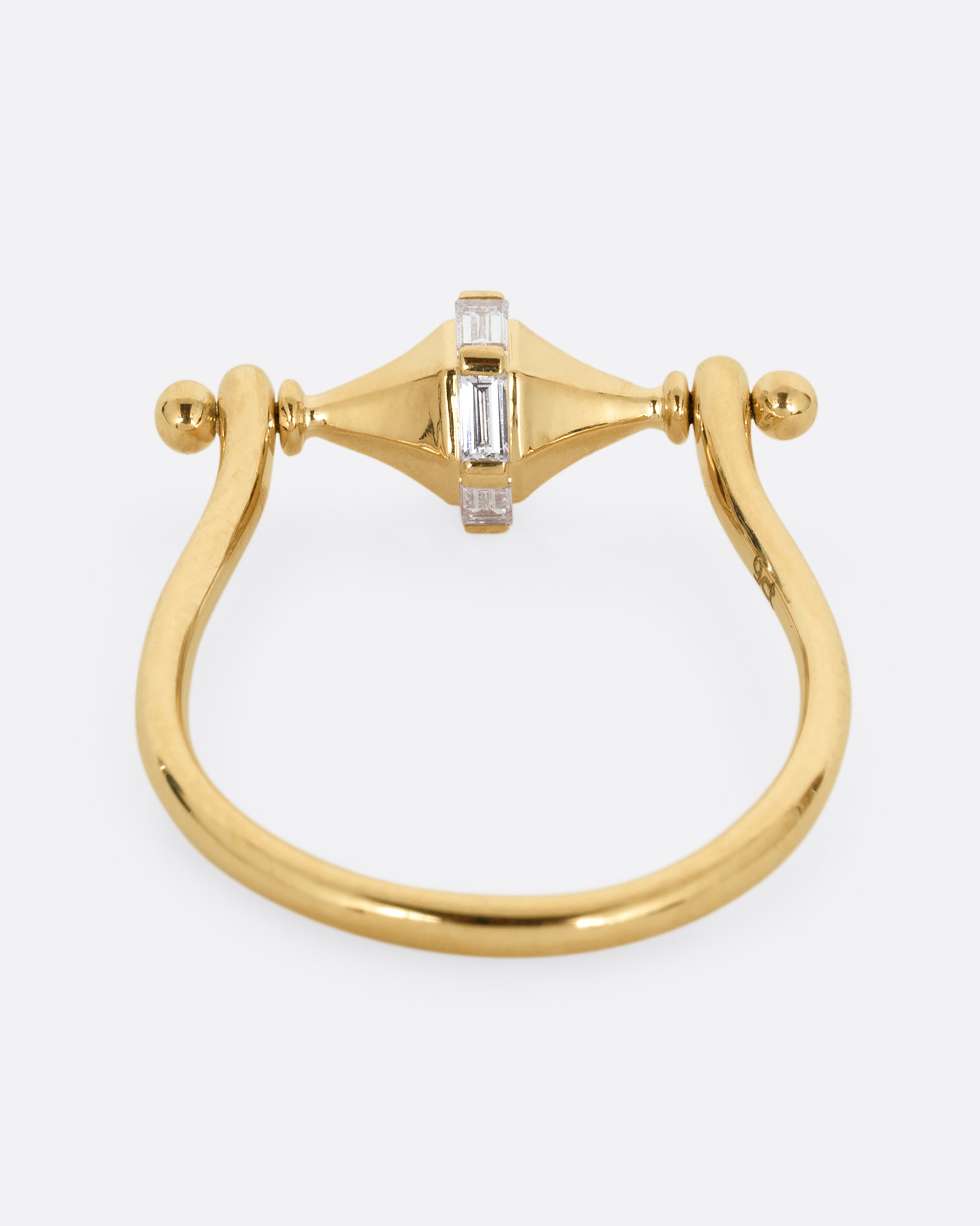 A yellow gold ring with a spin- able center and baguette diamonds. Shown from the back.