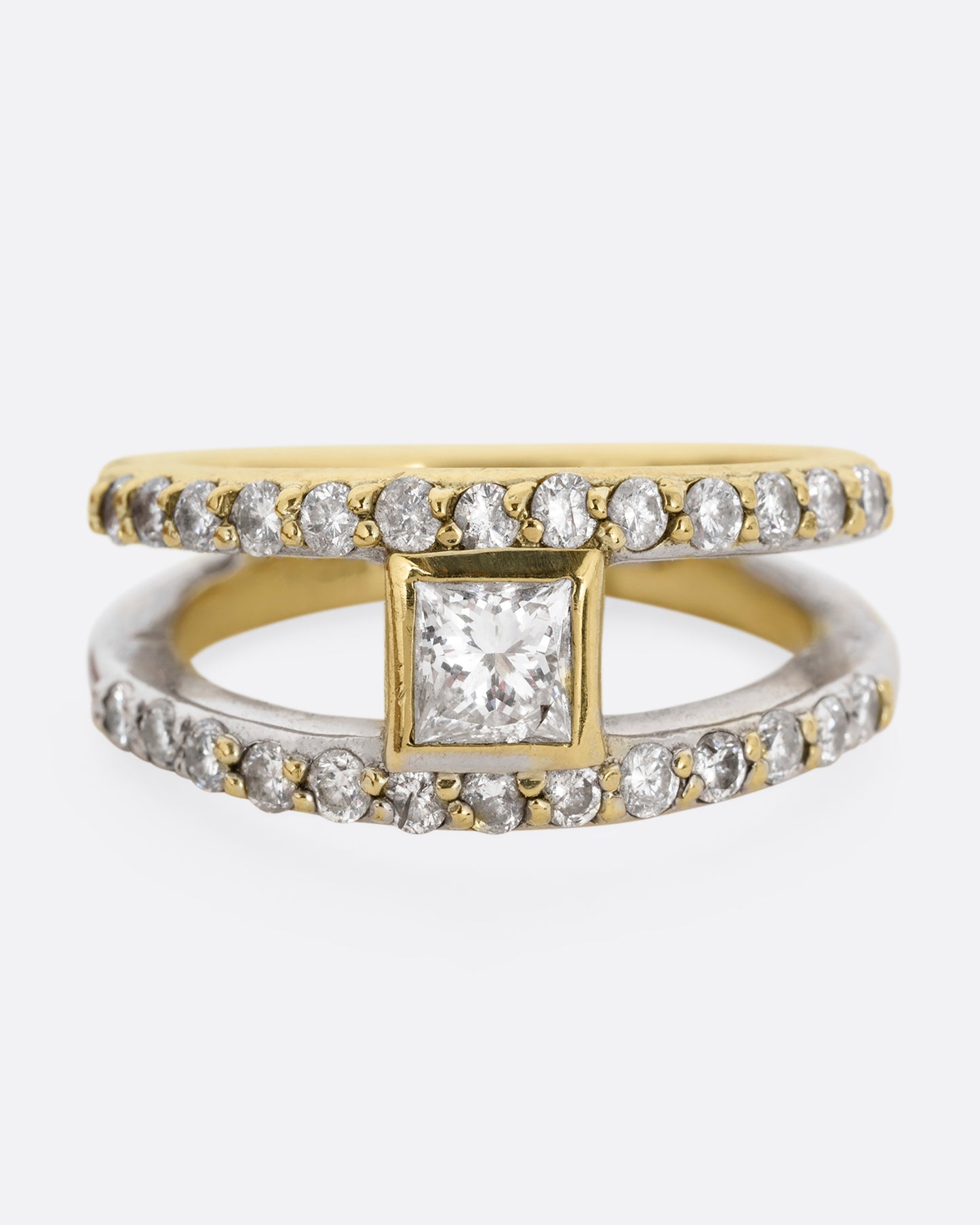 A yellow and white gold double band with pave diamonds and a center princess cut diamond. Shown from the front.