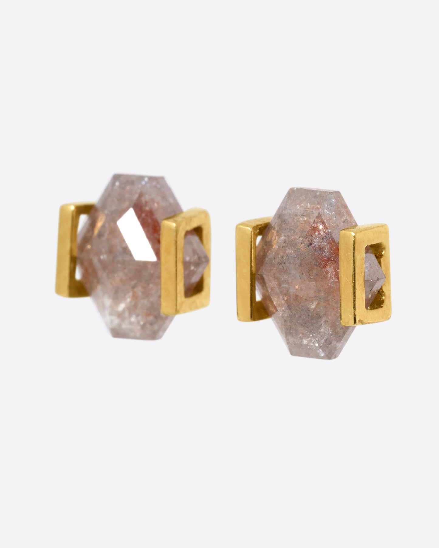 Yellow gold earrings with rustic diamonds in open rectangular settings. Shown from the side.