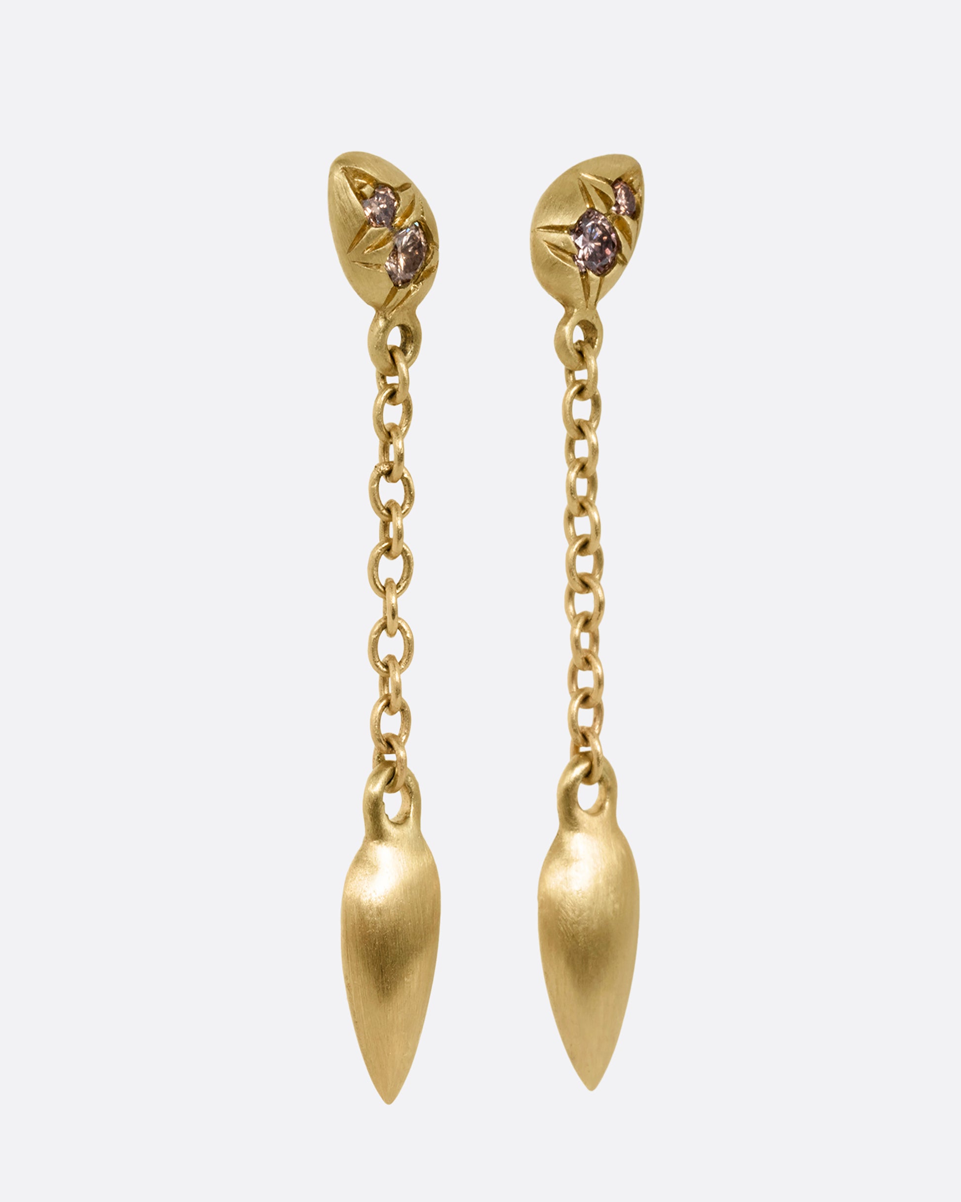 Yellow gold earrings with brown diamonds and cable chain drops. Shown from the side.