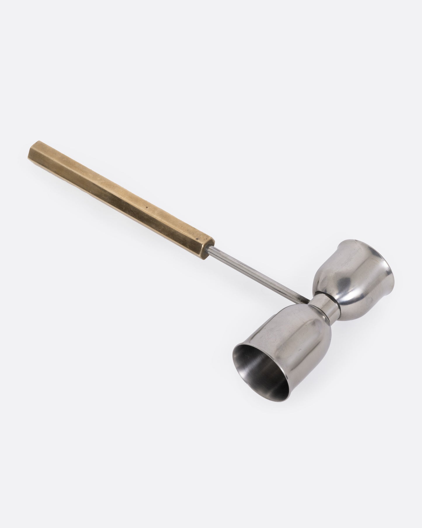An hourglass shaped jigger with a long handle, shown from the side.