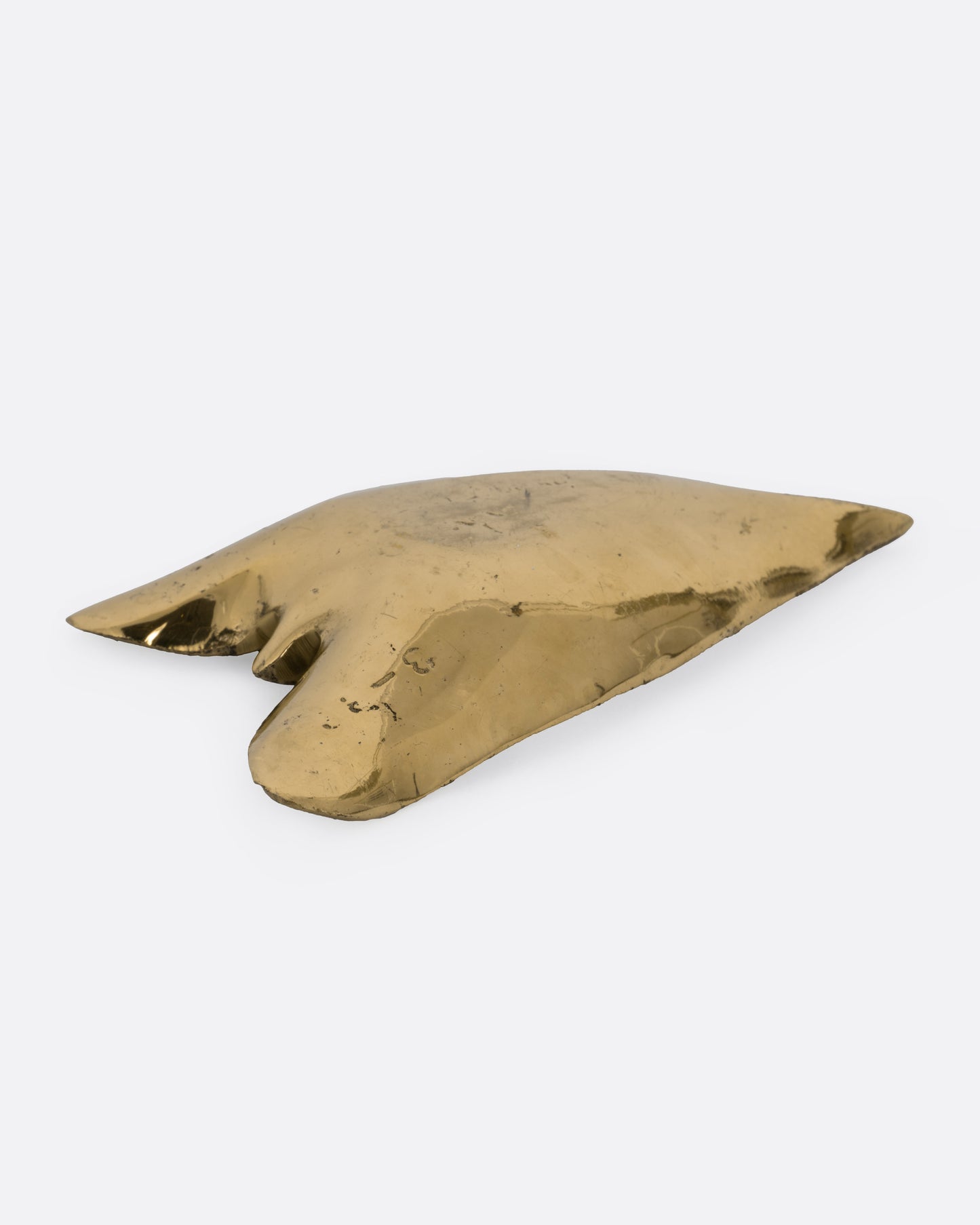 A brass calla lily leaf shaped dish, shown from the back.