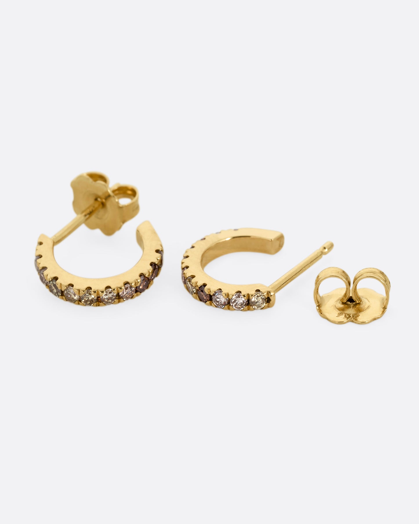 Small yellow gold hoops with green and brown pave diamonds. Shown laying flat.