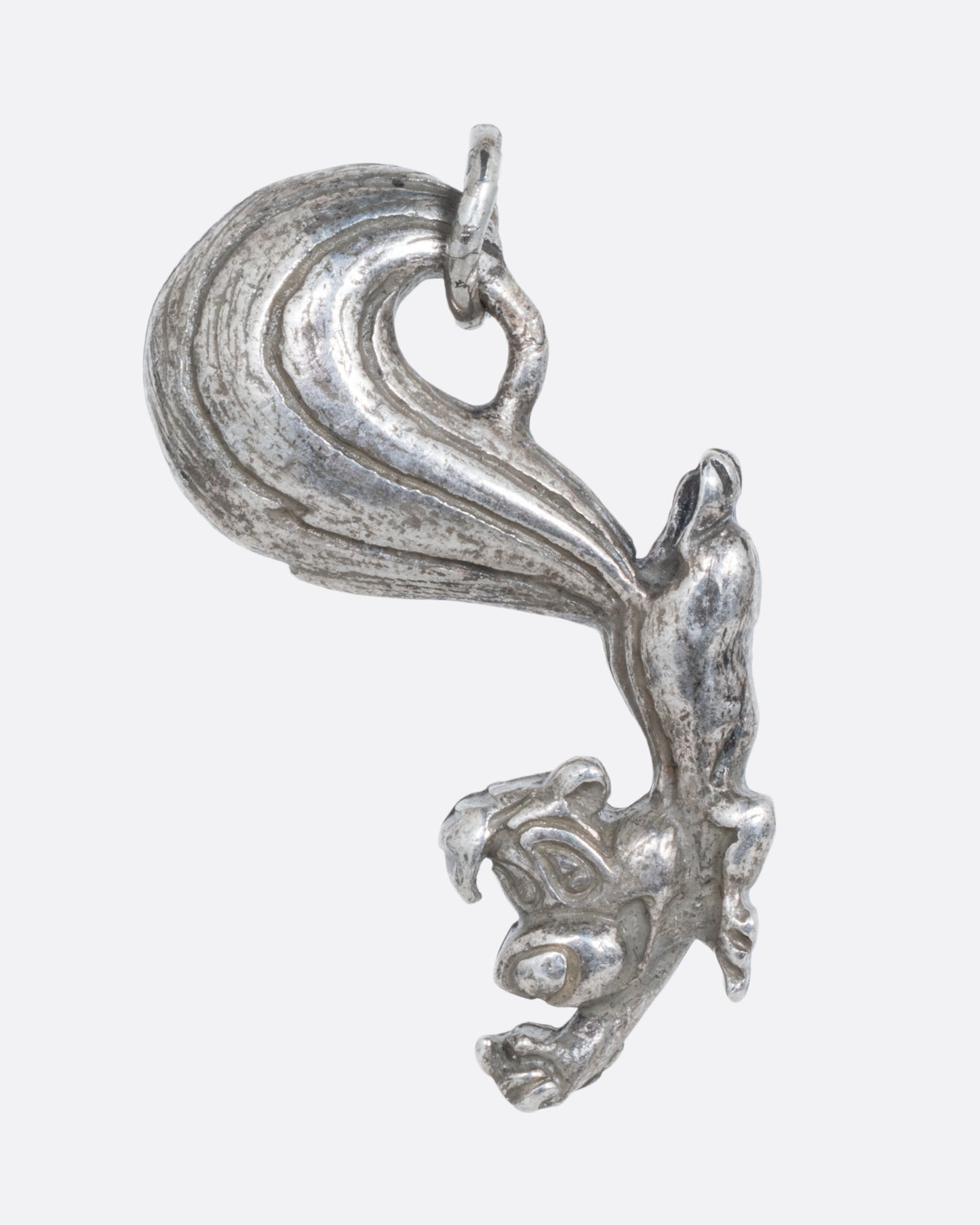 A silver Pepe Le Pew charm. Shown from the front.
