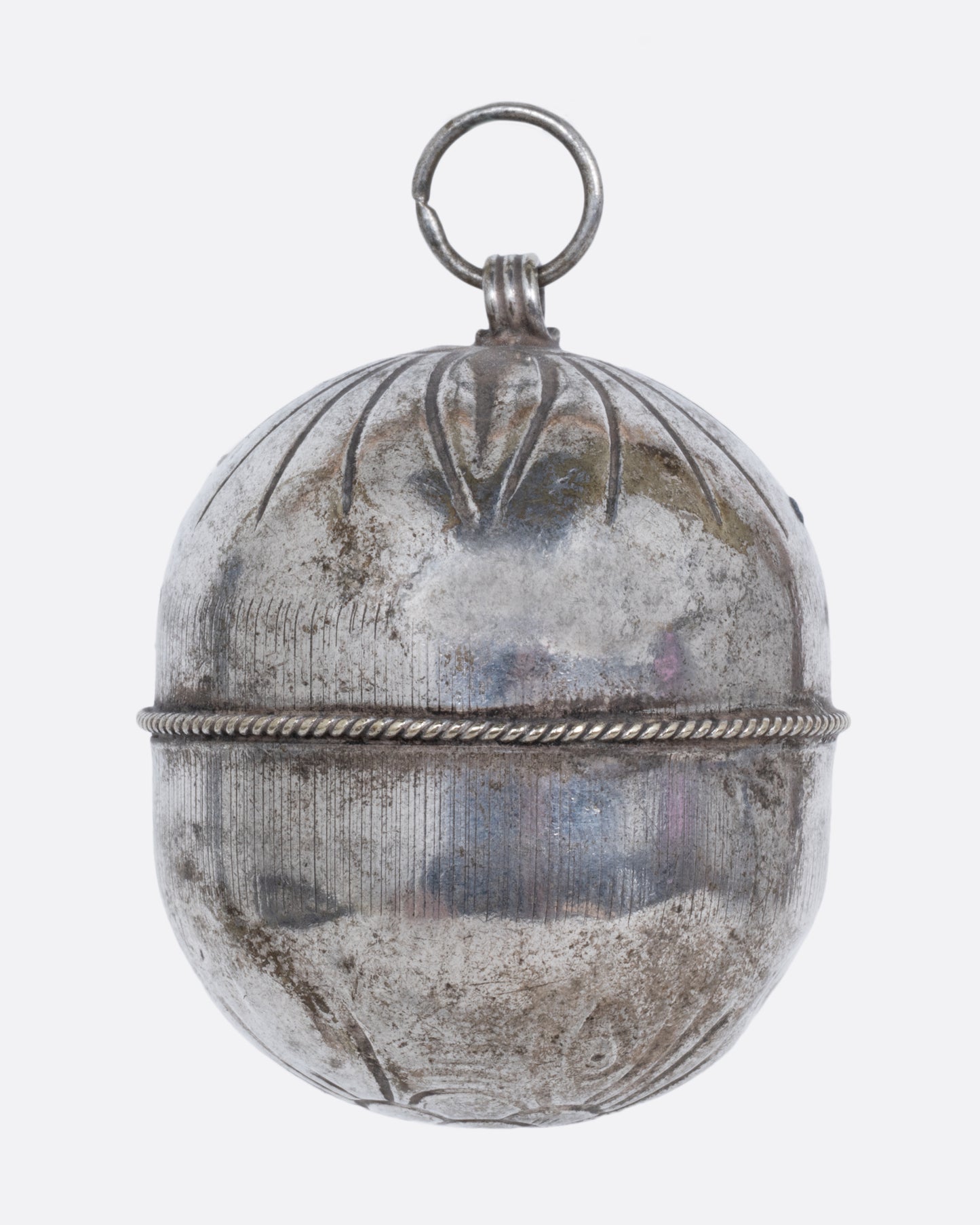 A silver engraved bell charm. Shown from the back.