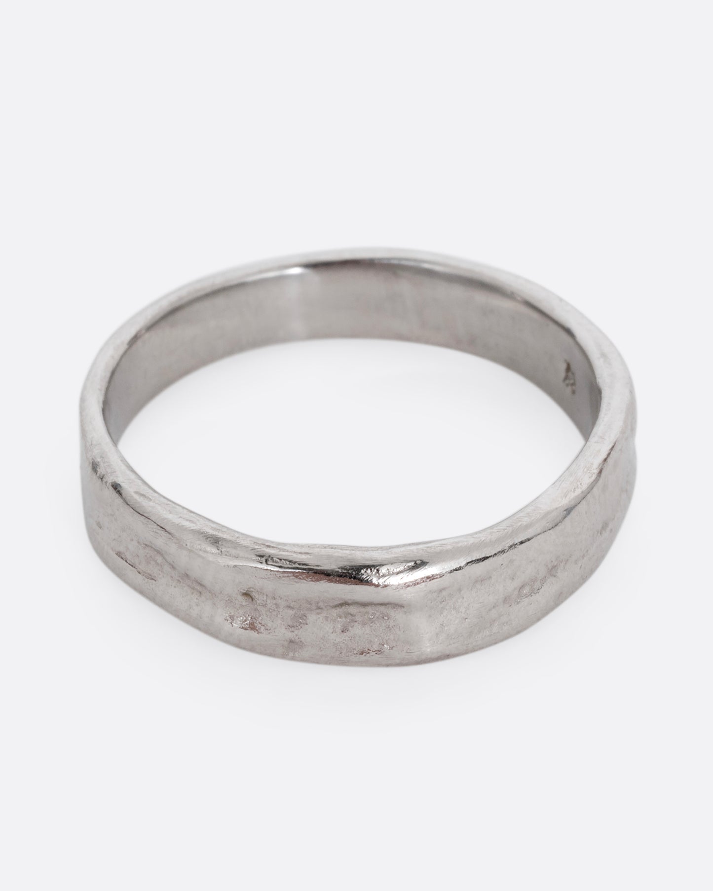 A platinum textured band with an irregular band, shown from slightly above.