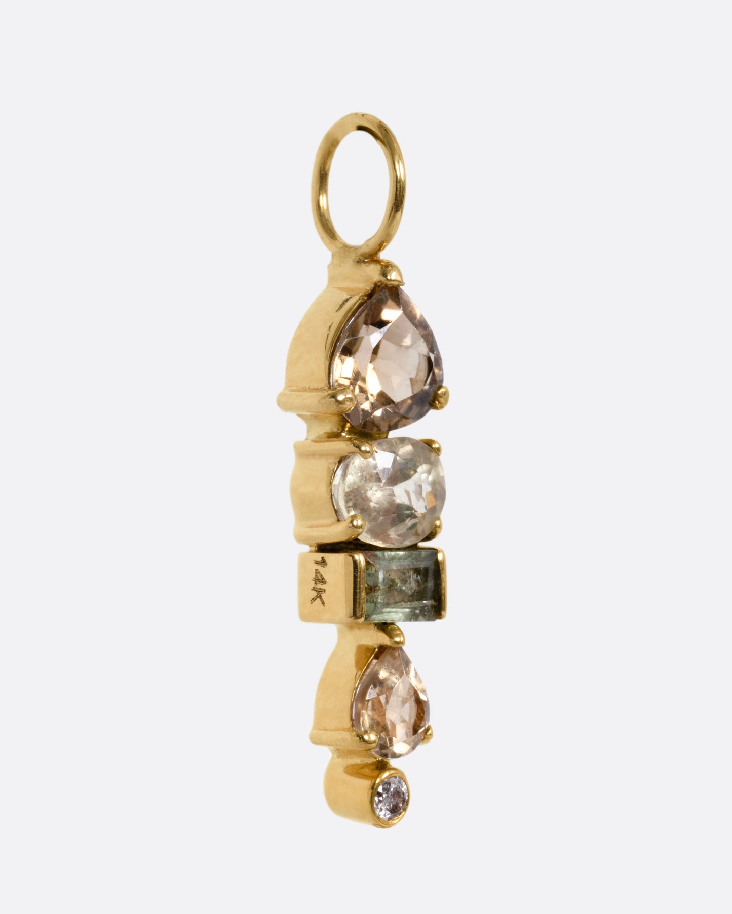 A yellow gold pendant with stacked tourmalines, sapphires, and diamonds, shown from the side.