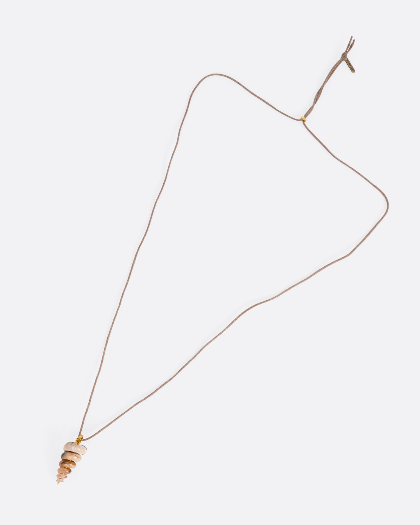A yellow gold pendant with a fossilized snail on a cord, shown from the front.