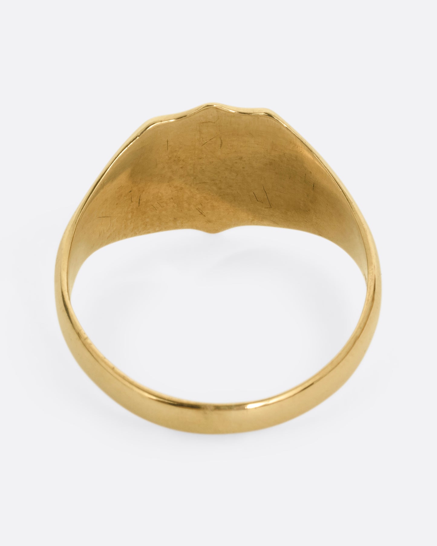A yellow gold shield shaped signet ring. Shown from the back.