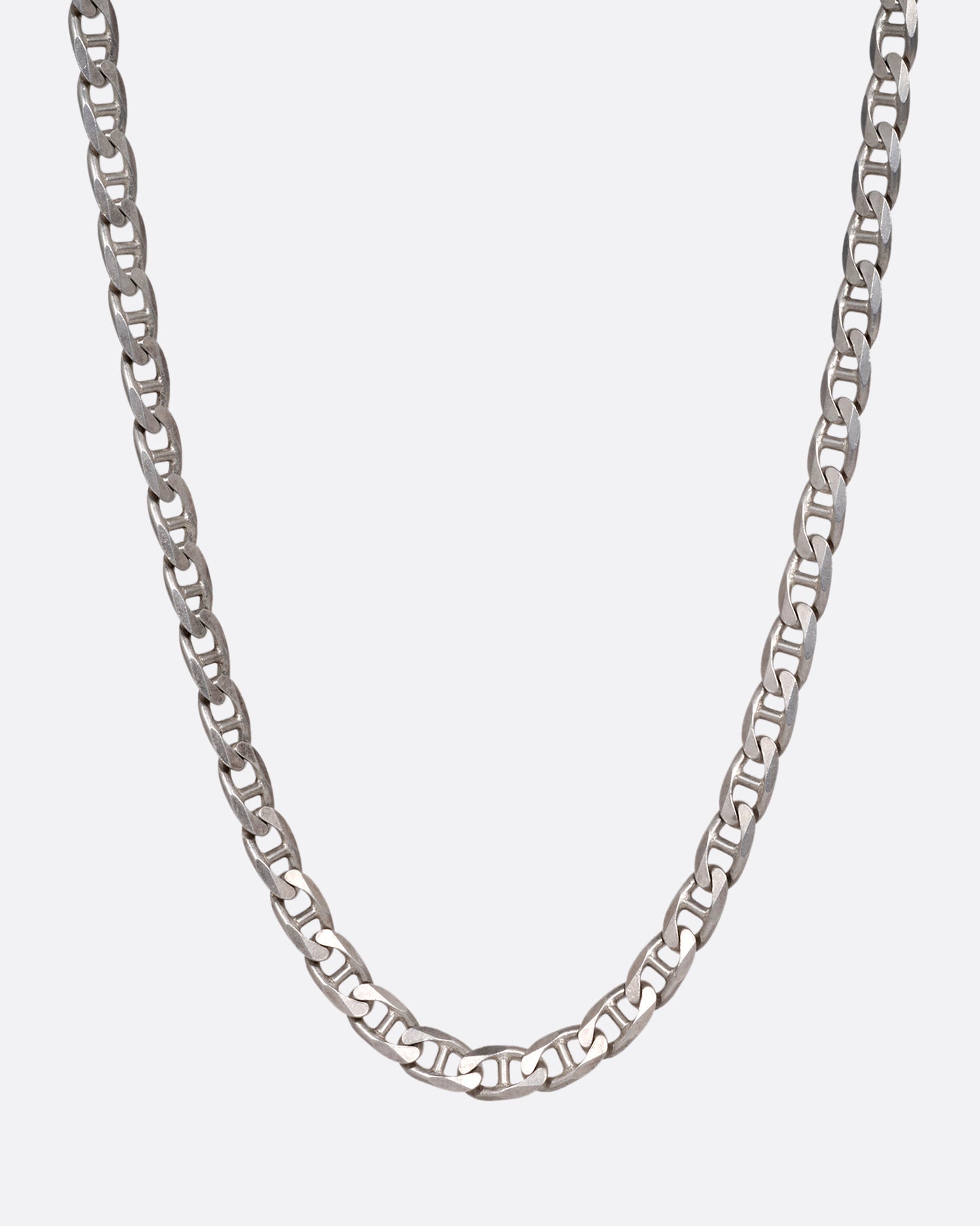 A silver anchor link chain necklace, shown from the front.