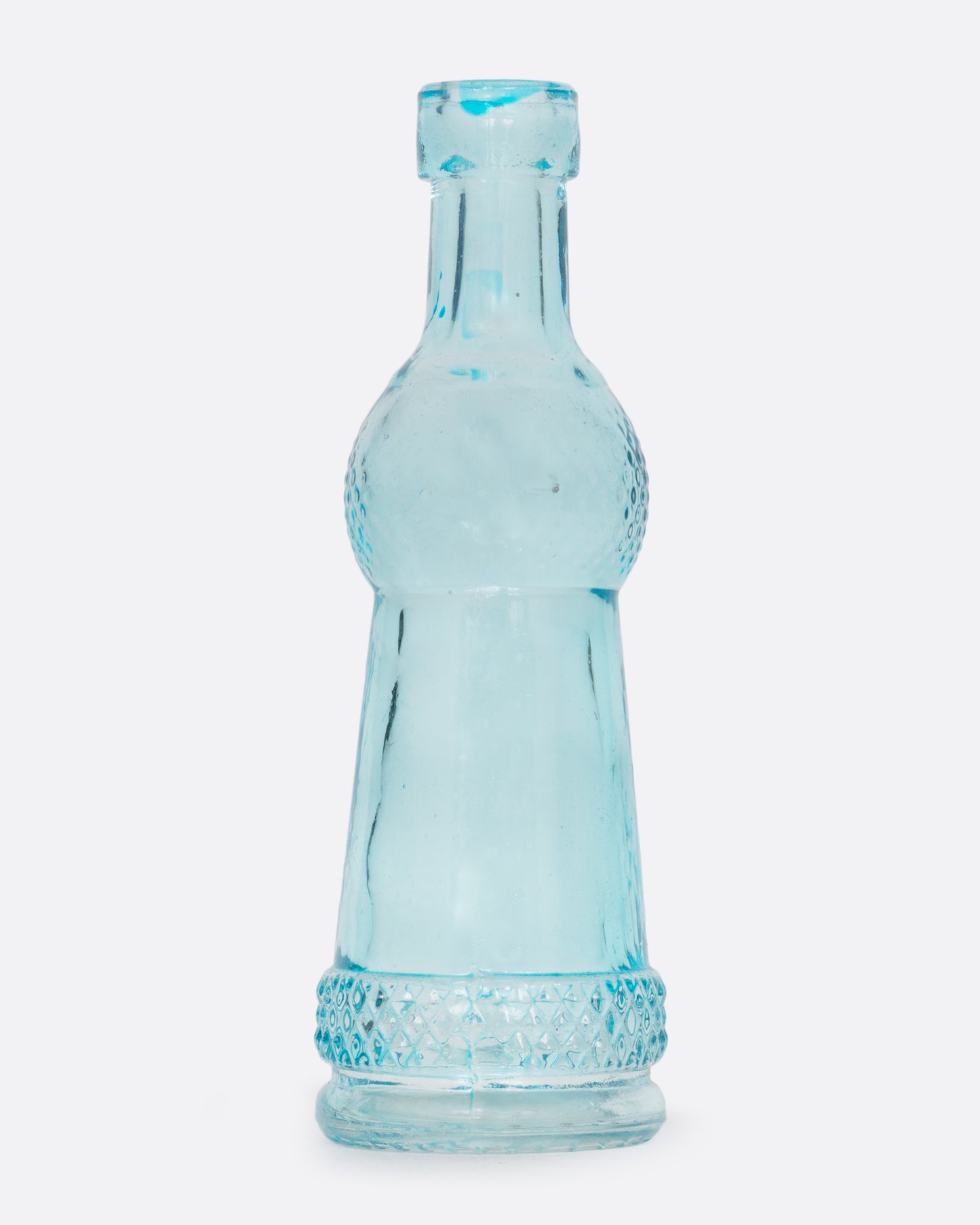 A tiny clear blue vase in a 'coke bottle' shape. Shown from the front.