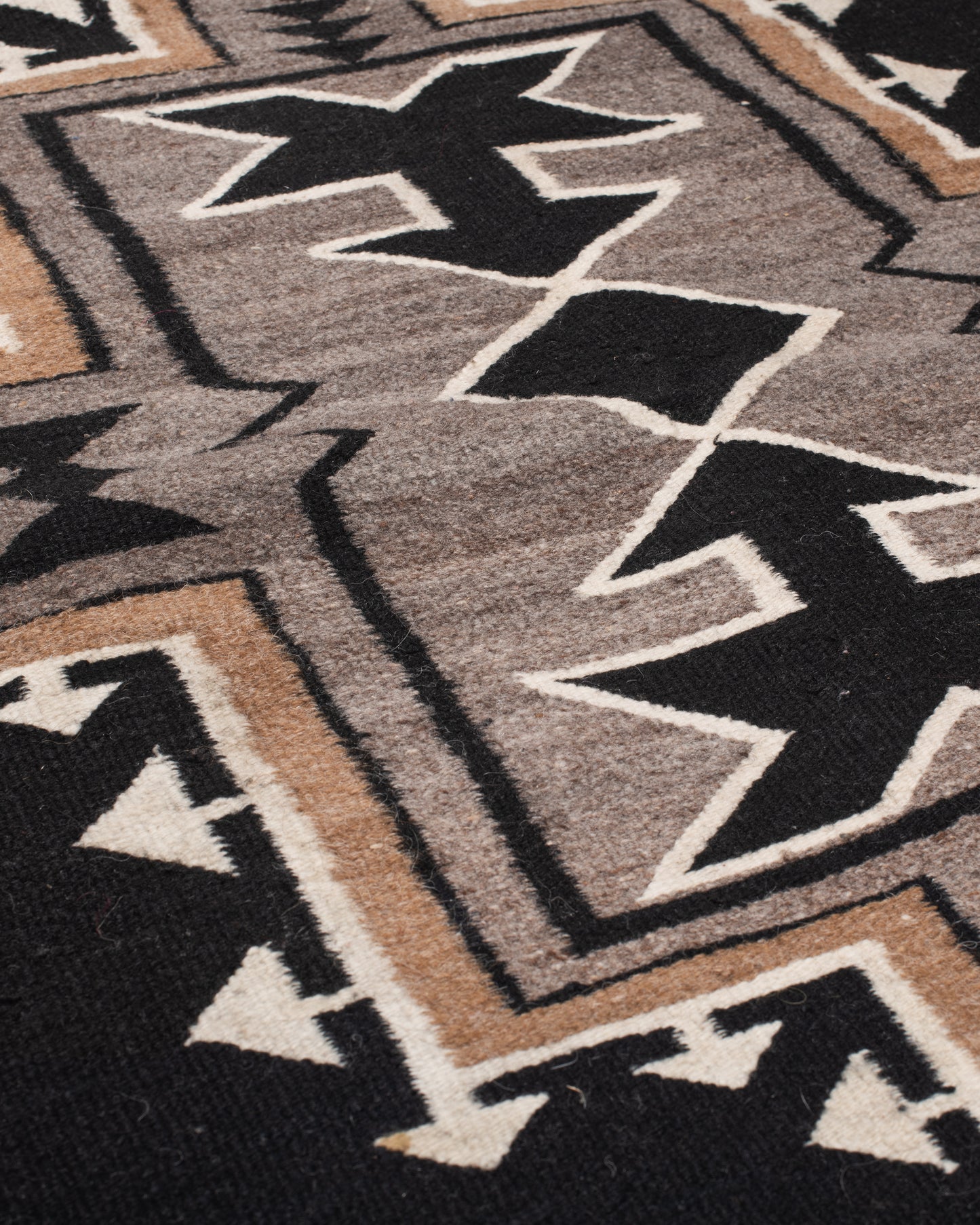 A vintage Navajo rug with the traditional Two Grey Hills weaving