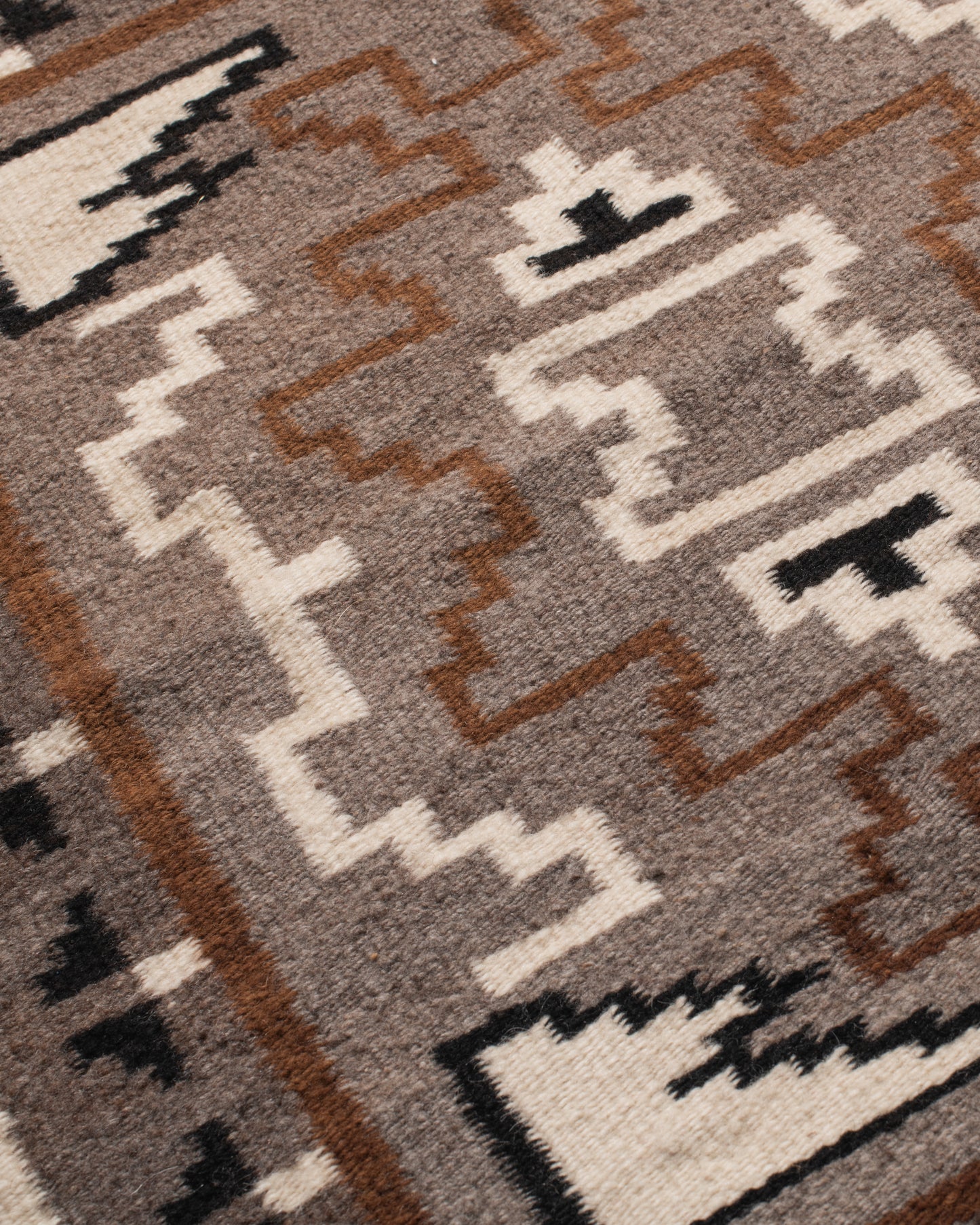 A vintage Navajo square rug with the traditional Two Grey Hills weaving