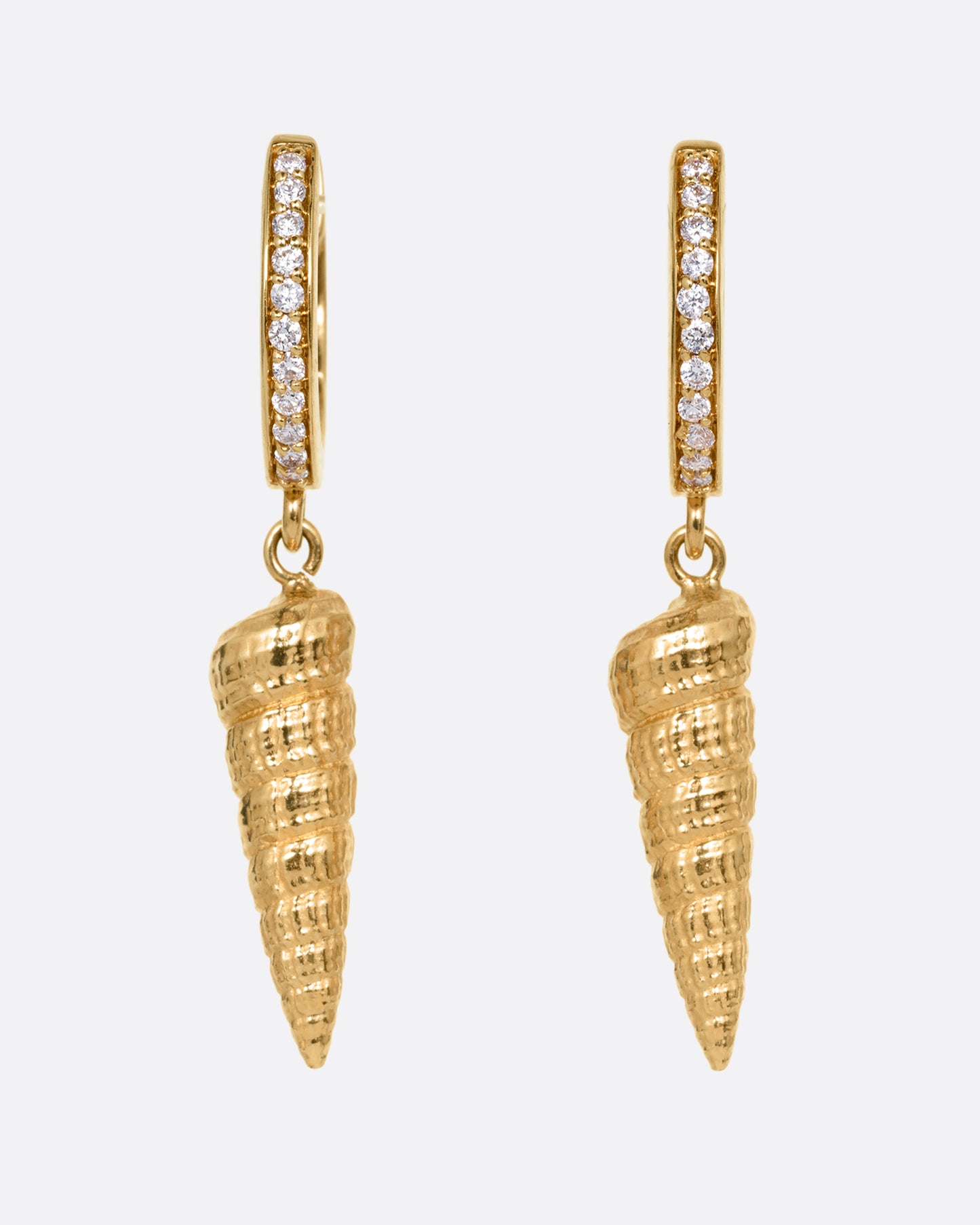 A pair of yellow gold diamond lined hoop earrings with seashell drops. Shown from the front.