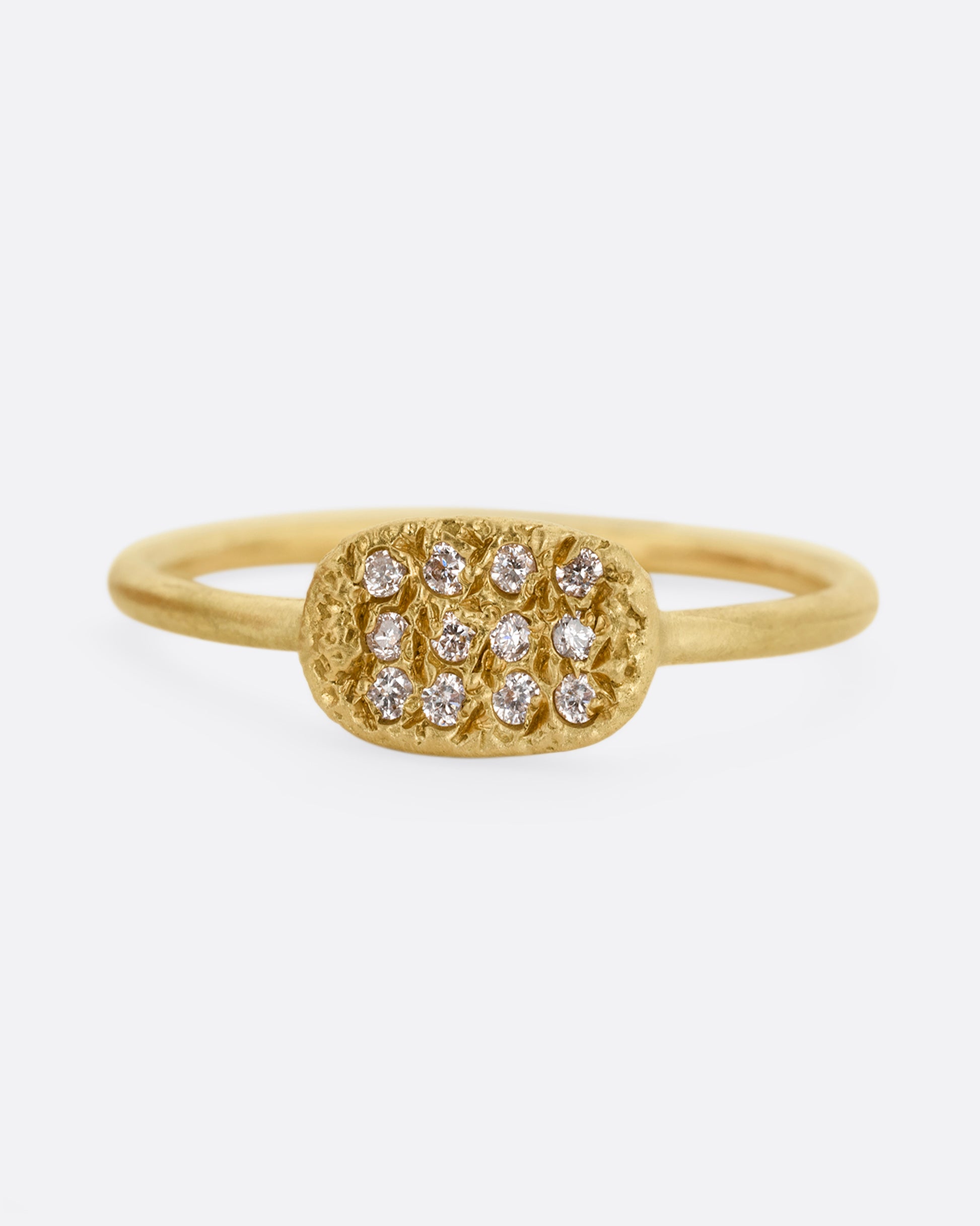 A yellow gold ring with a textured oval face with twelve white diamonds, shown from the front.