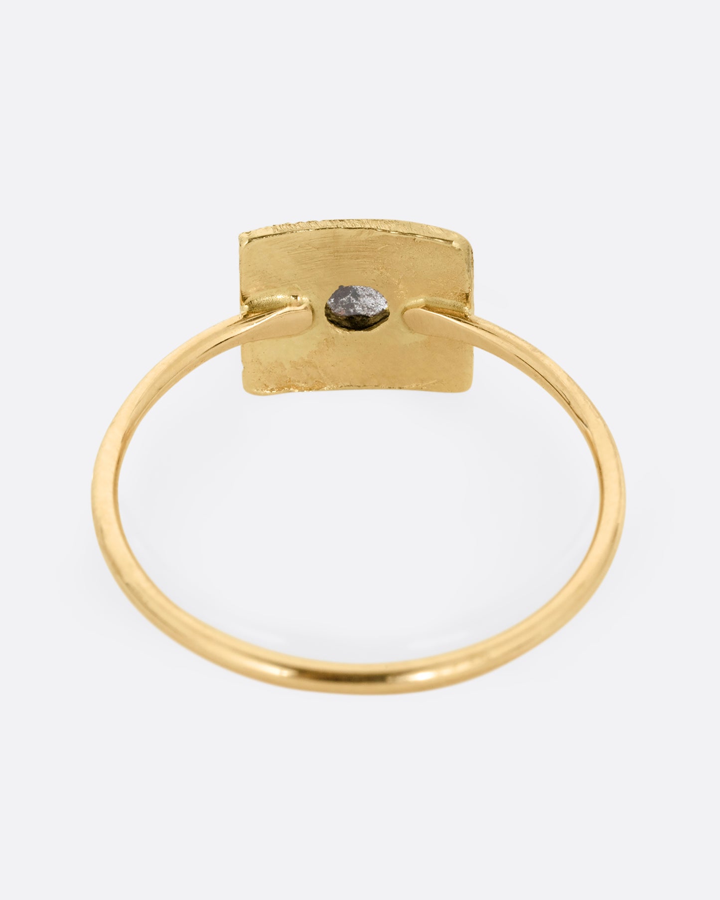 A yellow gold ring with a rectangular face and a rose cut diamond. Shown from the back.
