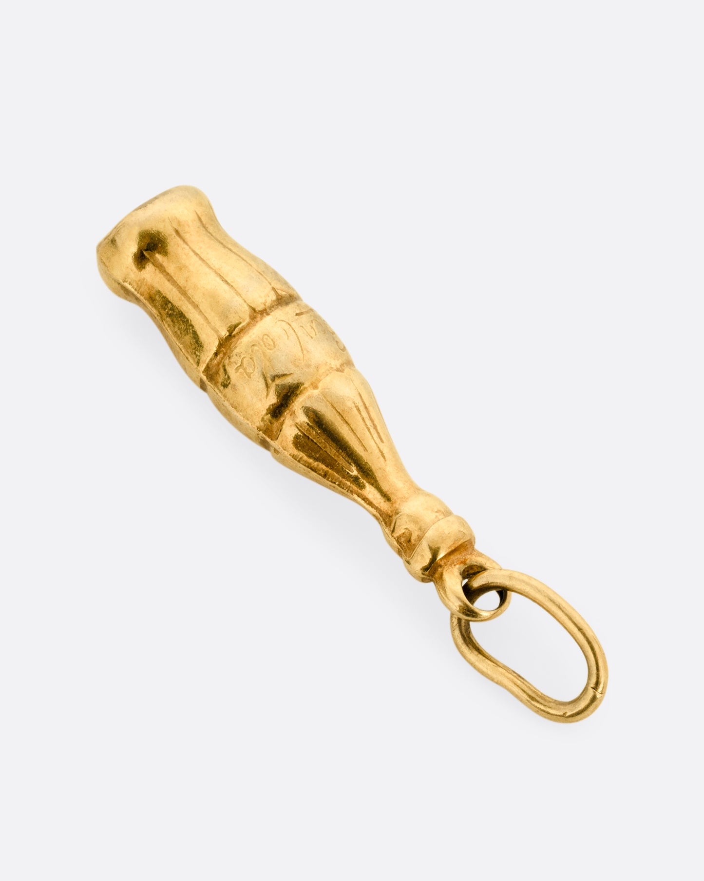 A yellow gold Coca-Cola bottle charm shown from the side.