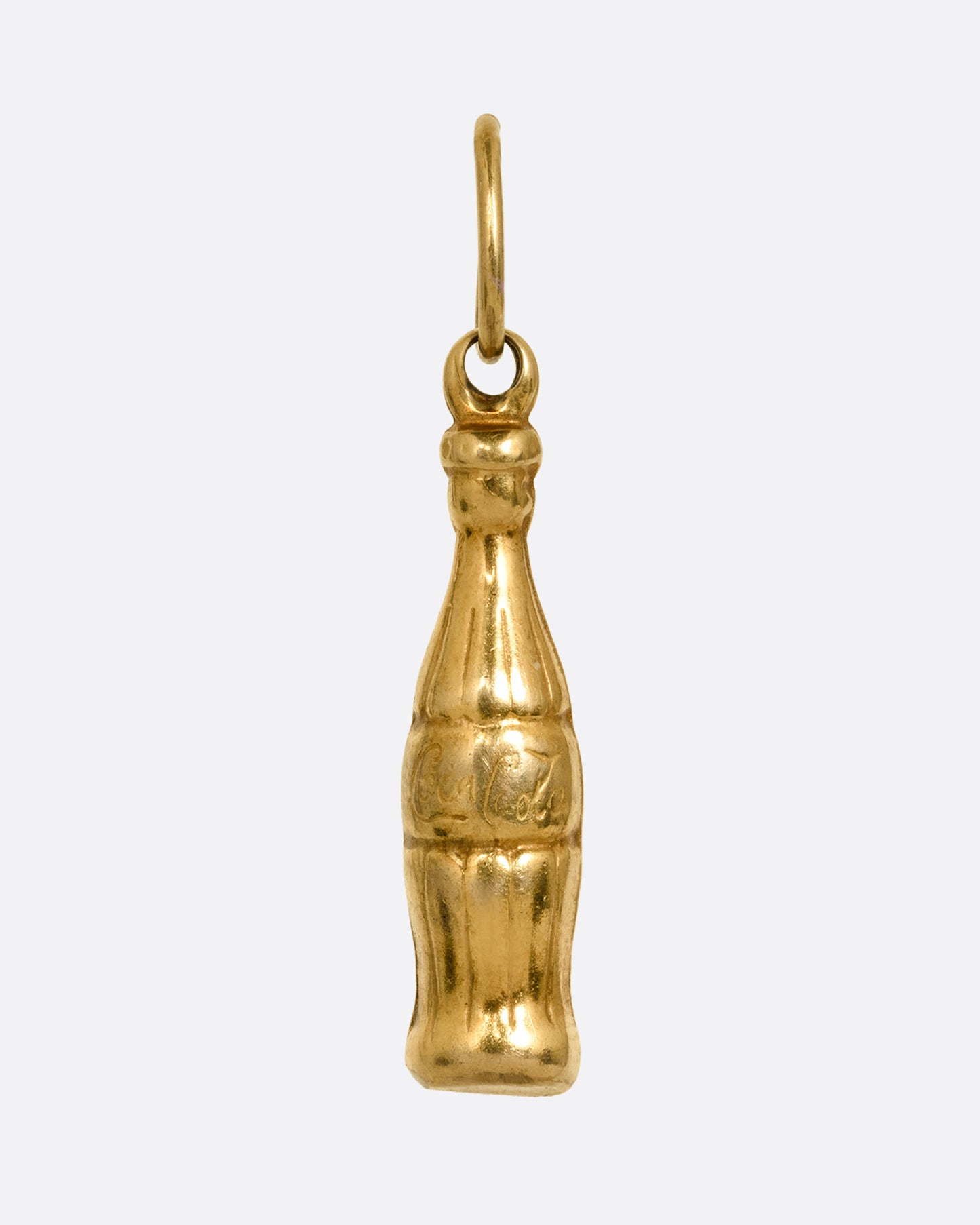 A yellow gold Coca-Cola bottle charm shown from the front.