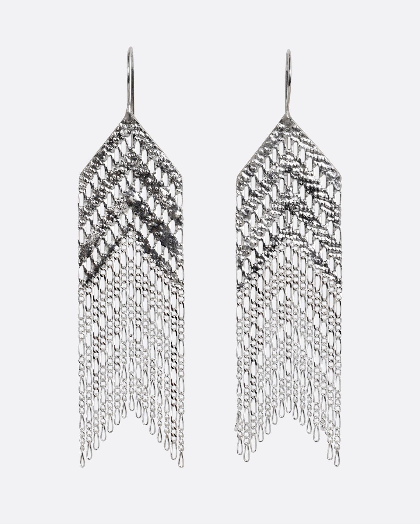 A pair of arrow shaped silver dangle earrings with Figaro chain fringe. Shown from the front.
