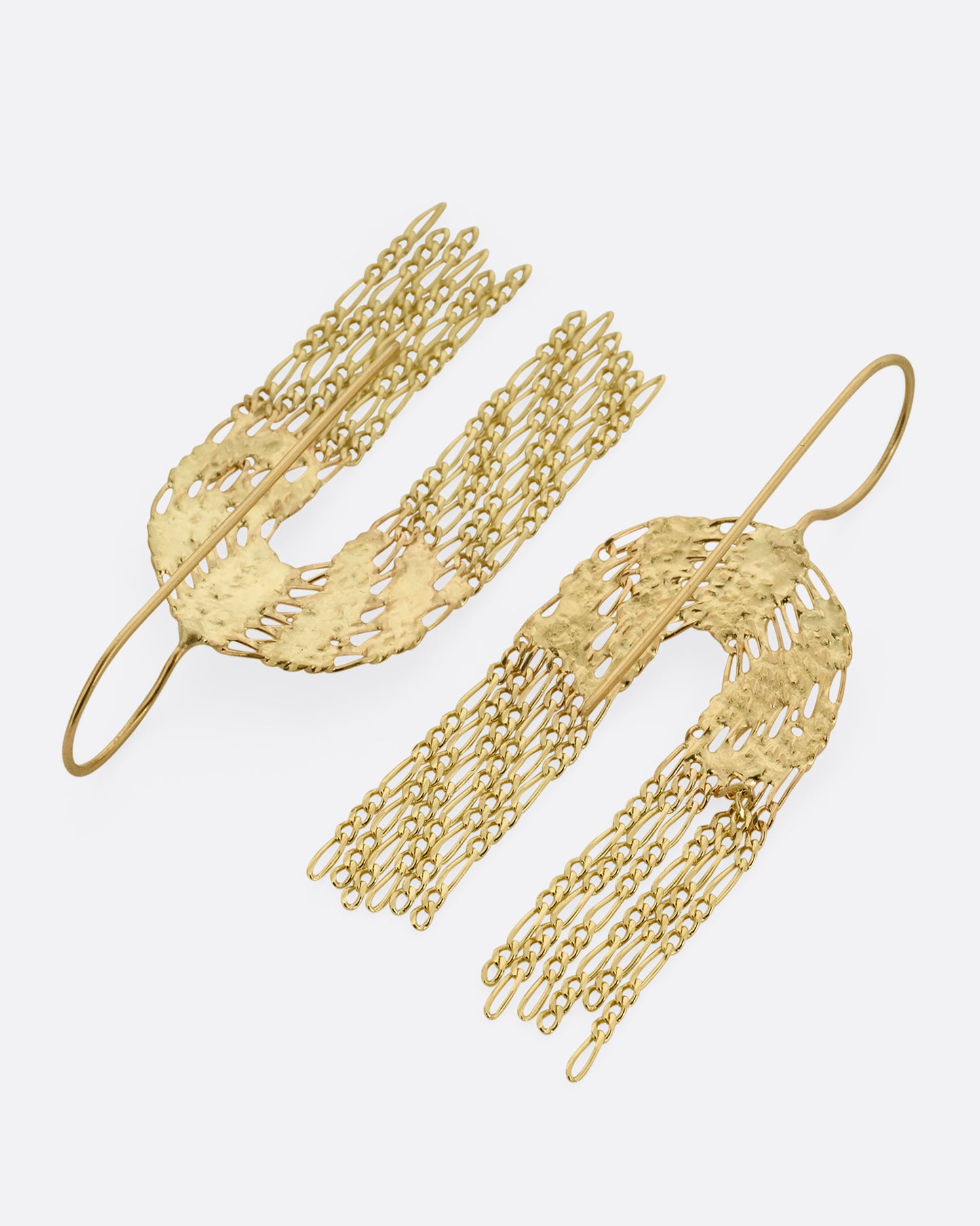 A pair of yellow gold dangle earrings with soldered rainbow shaped tops and Figaro chain fringe bottoms. Shown from the back.