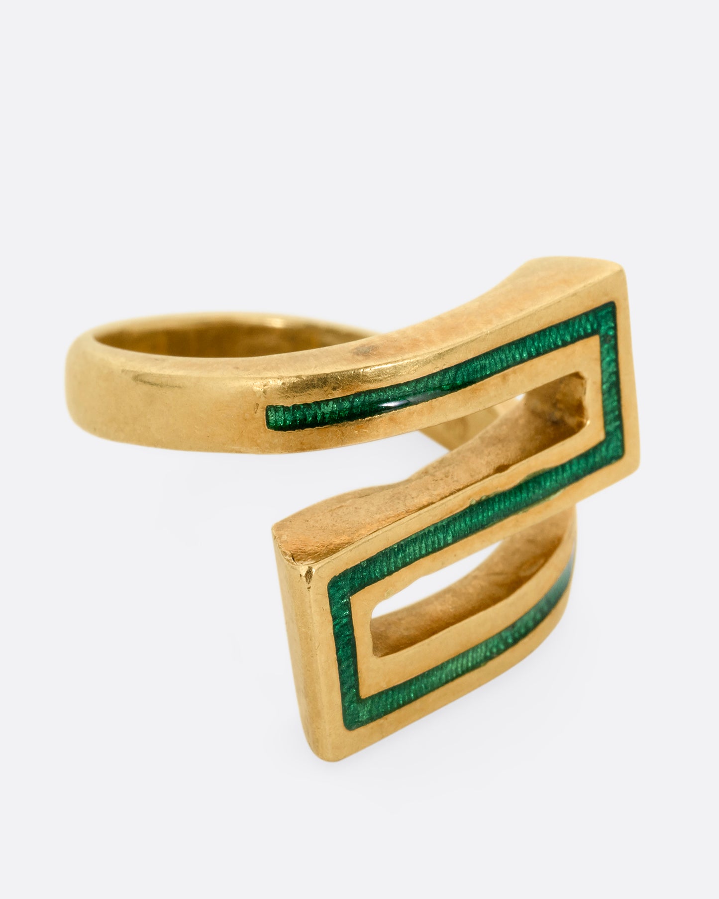A yellow gold Greek Key ring with a zigzag pattern in green enamel, shown from the side.