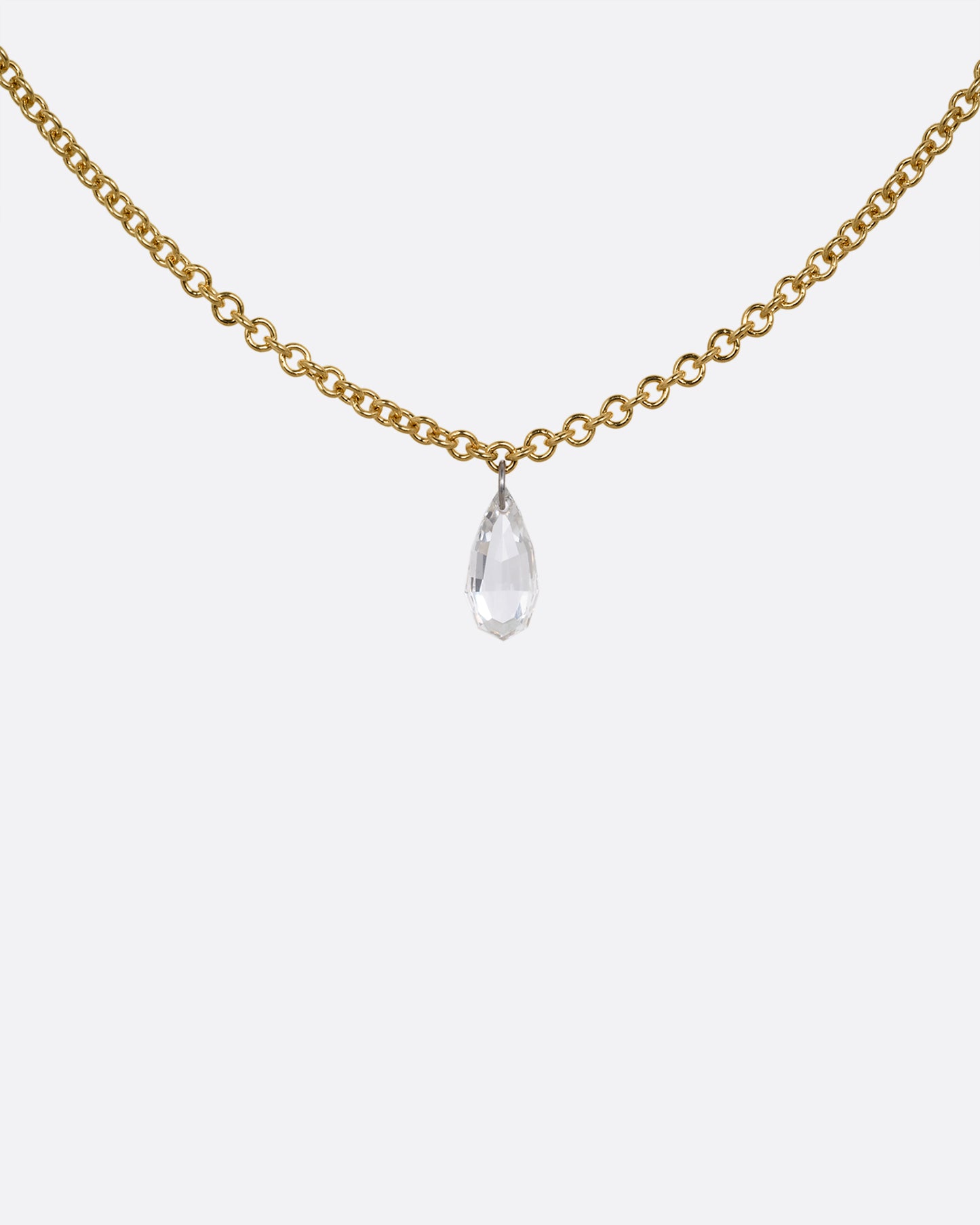 A yellow gold cable chain necklace with a pear shaped diamond. Shown from the front.
