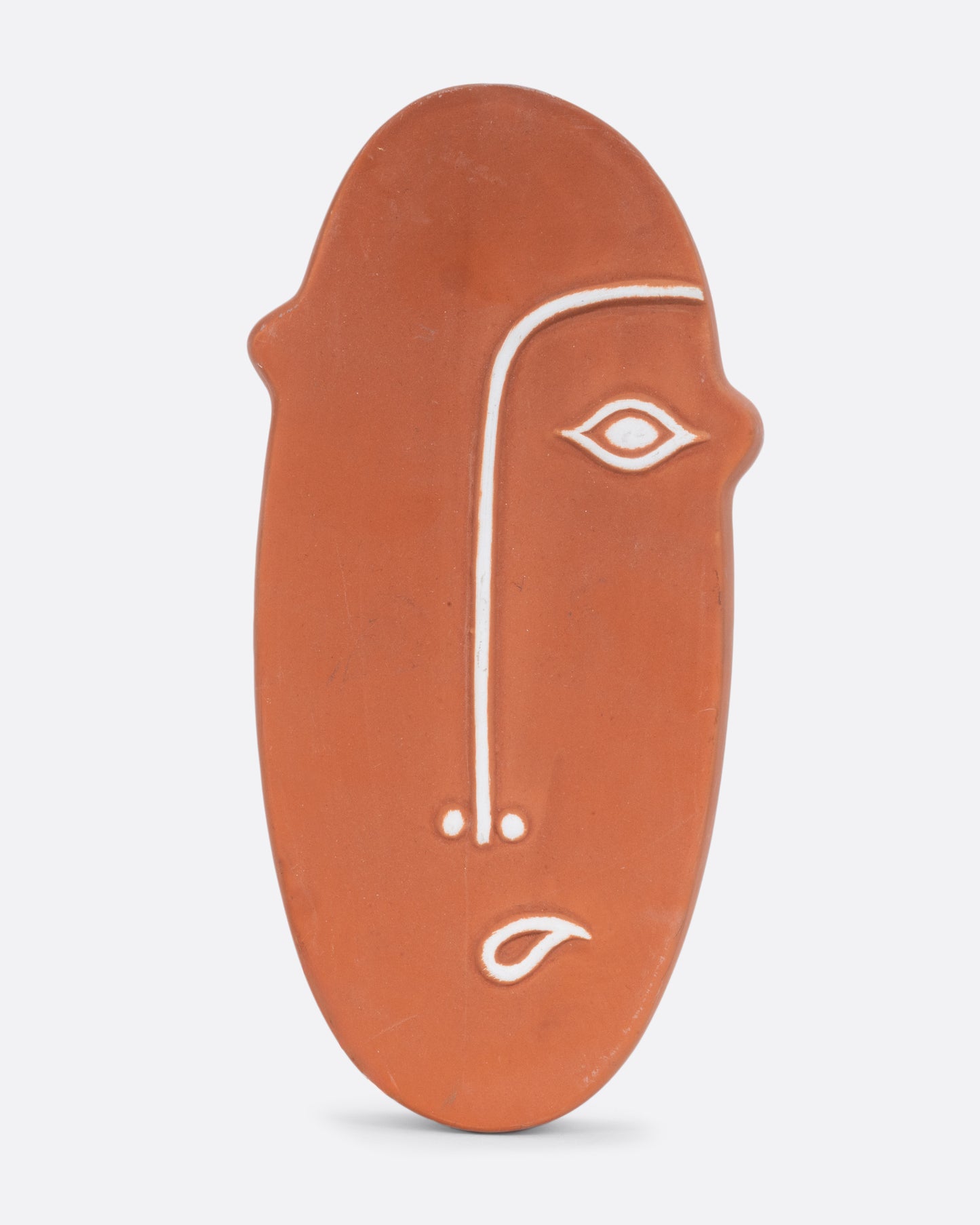 A terracotta face- shaped wall pocket with an opening at the top for plants. Shown from the front.