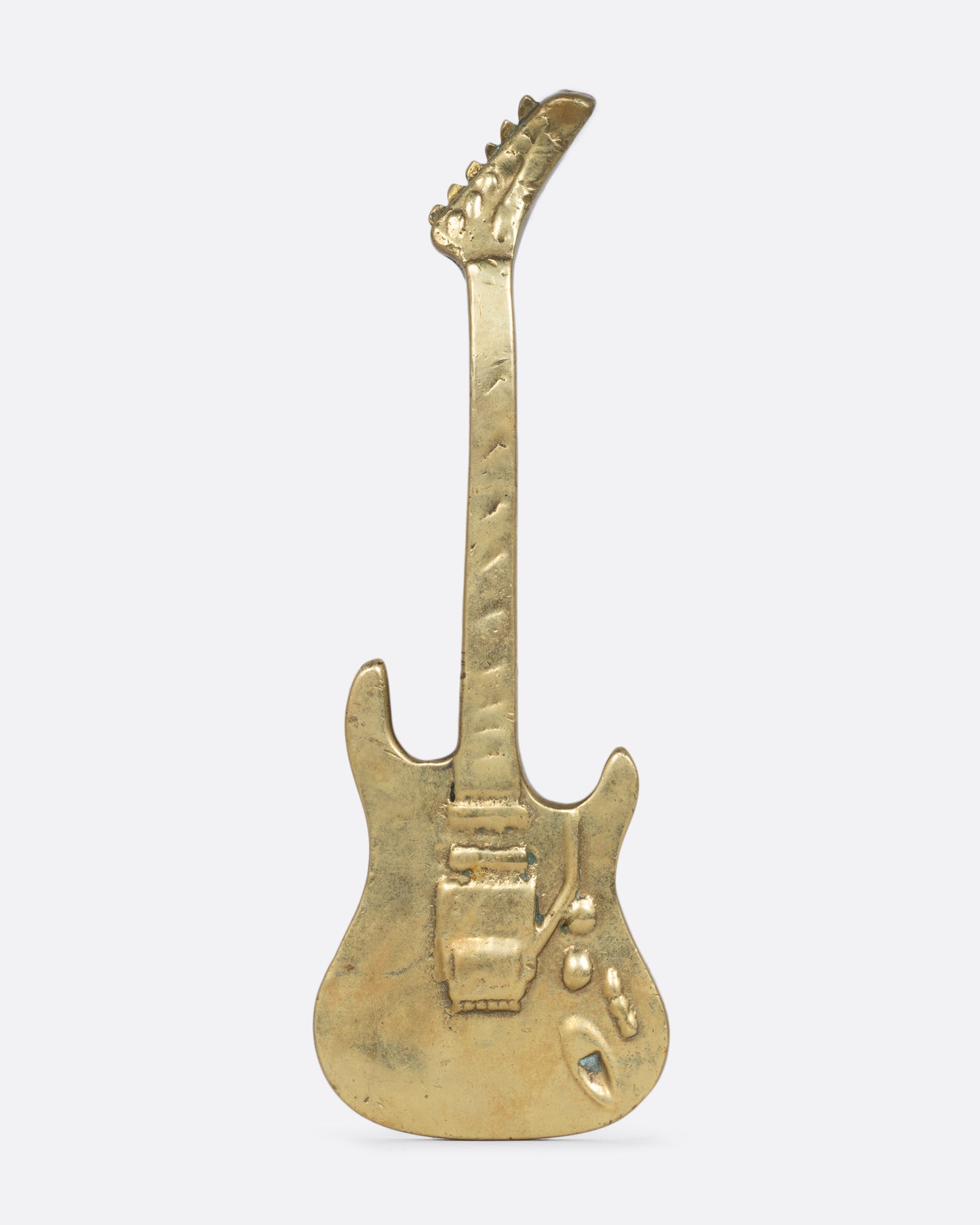 A brass electric guitar door handle shown from the front.