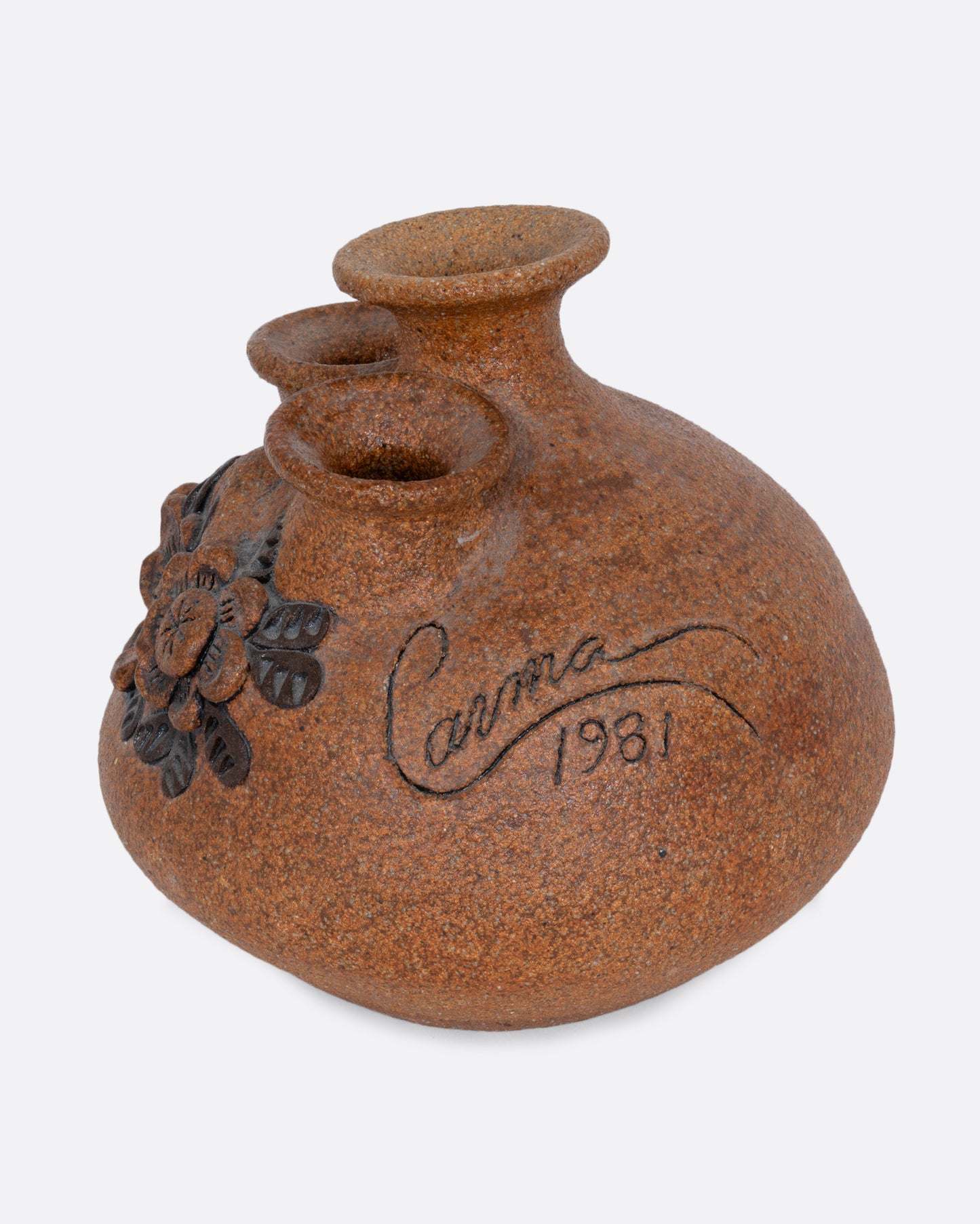 A sand art pottery vase with three openings for flowers and a floral pattern along the front. Shown from the side with the artist's signature and date.