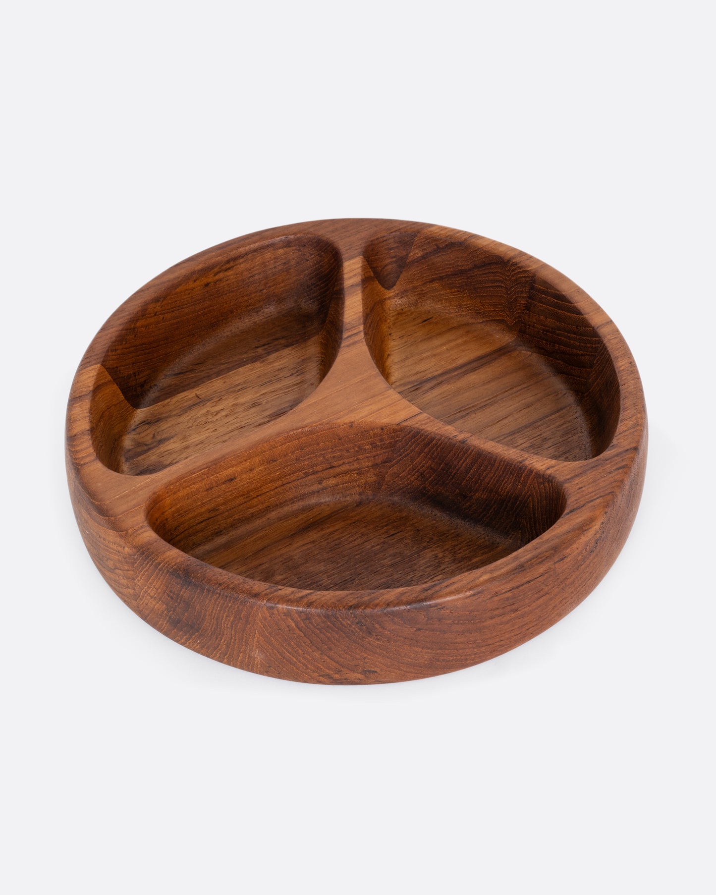 A round wooden tray with three separated sections. Shown from the top.
