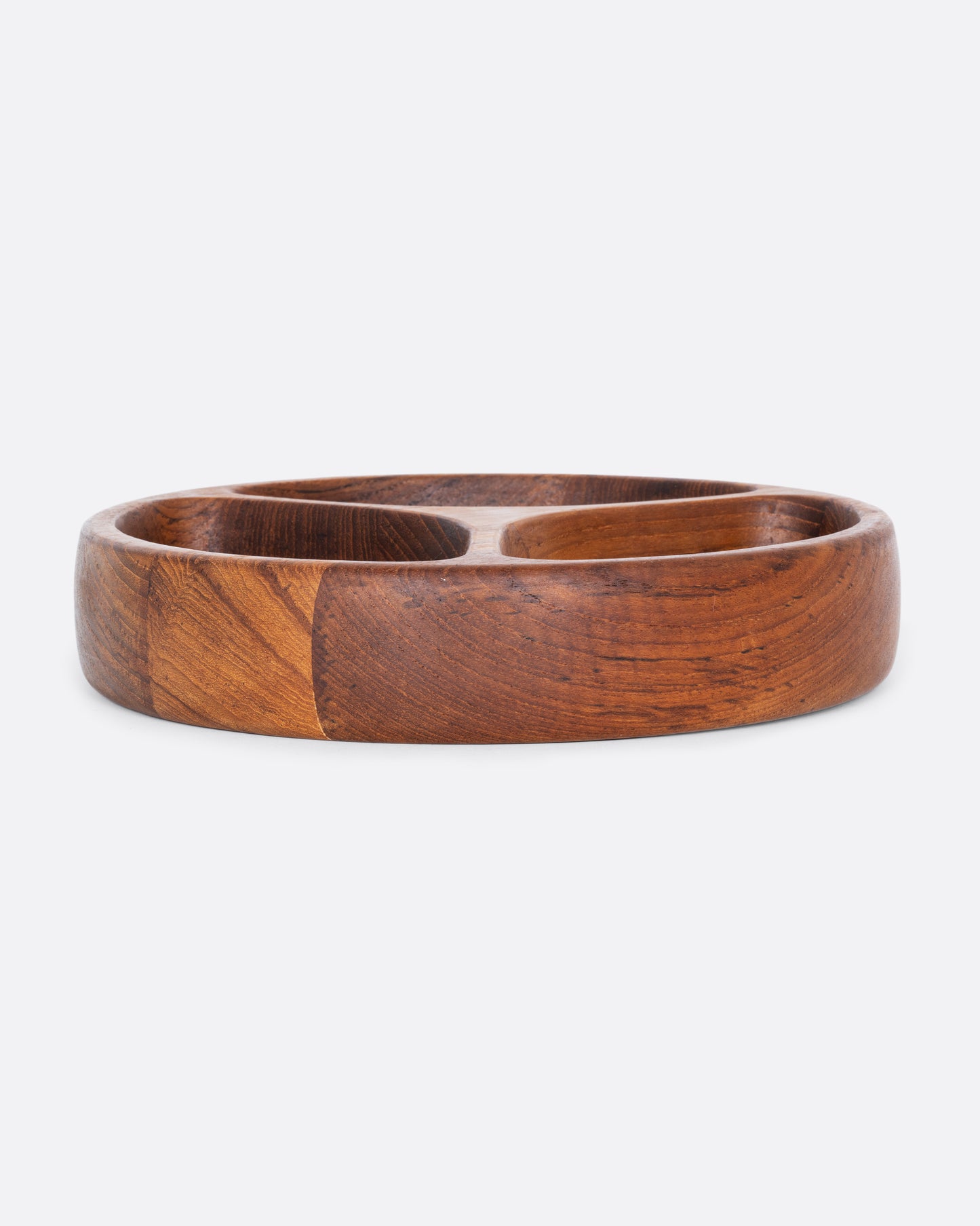 A round wooden tray with three separated sections. Shown from the side.