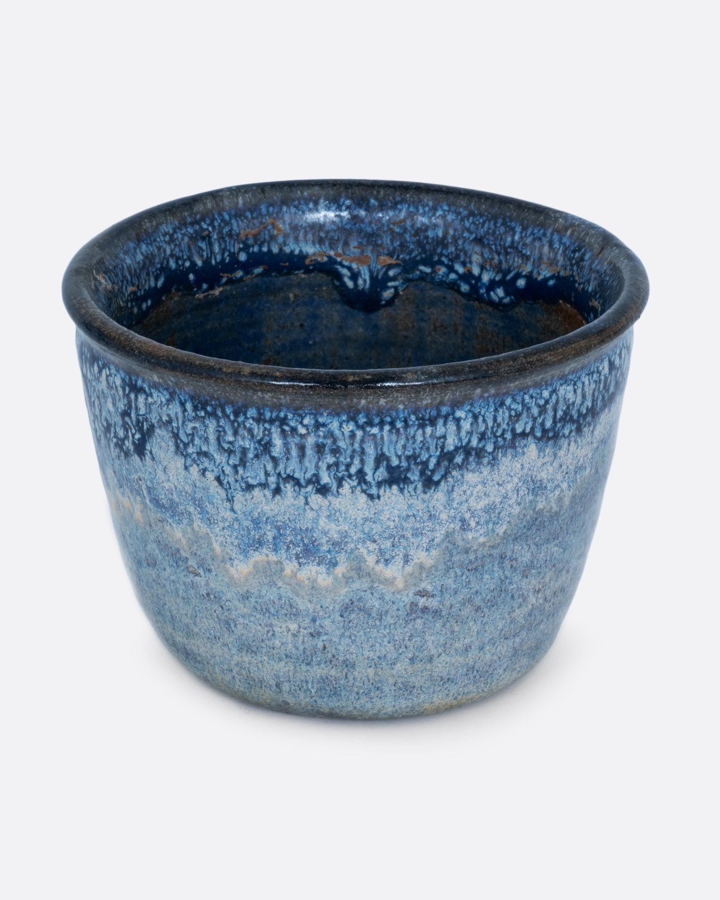 A pot with an azure glaze and drainage hole. Shown from the front.