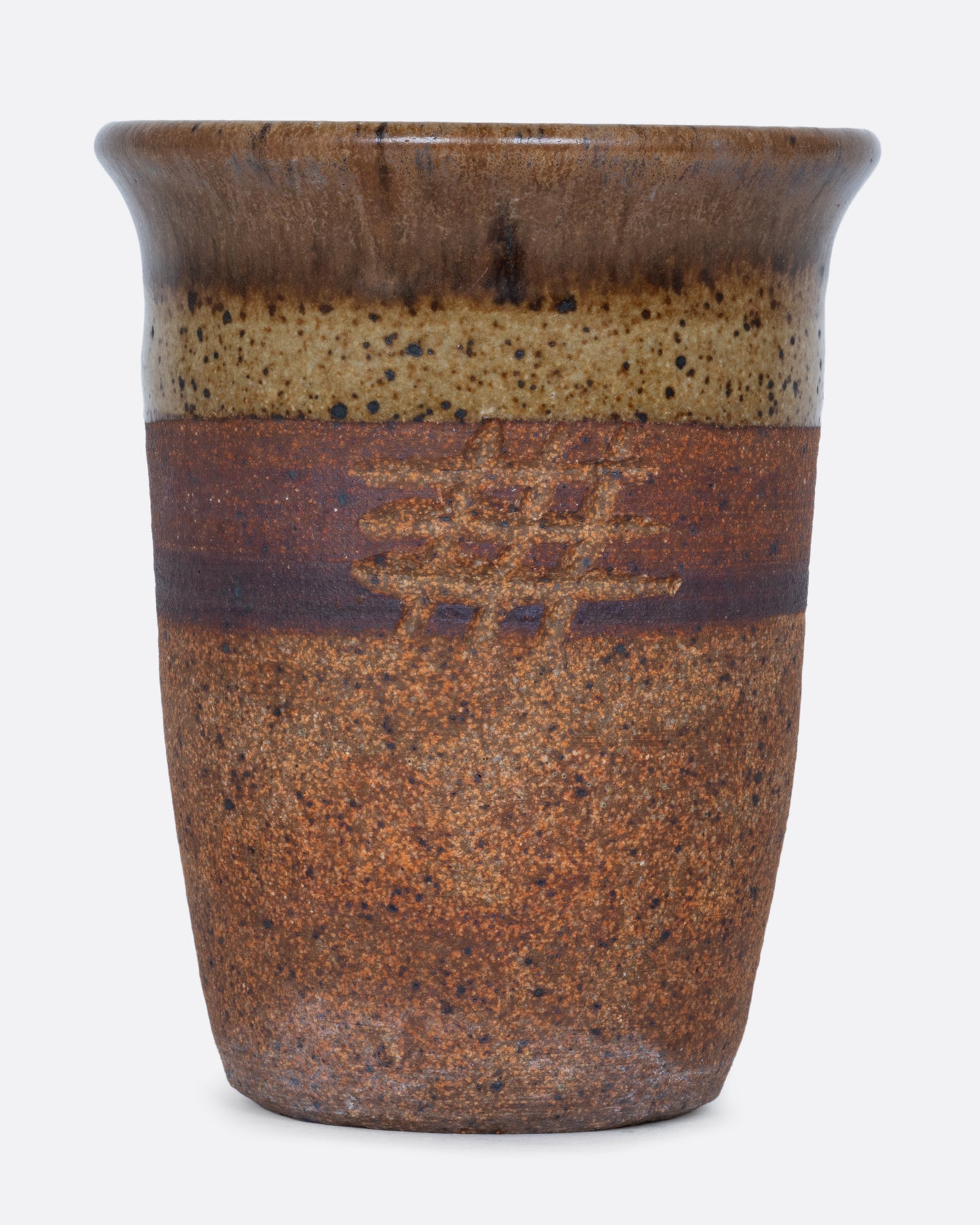 A striped brown pot with a hatched etching, a drainage hole at its base, and a textural finish.