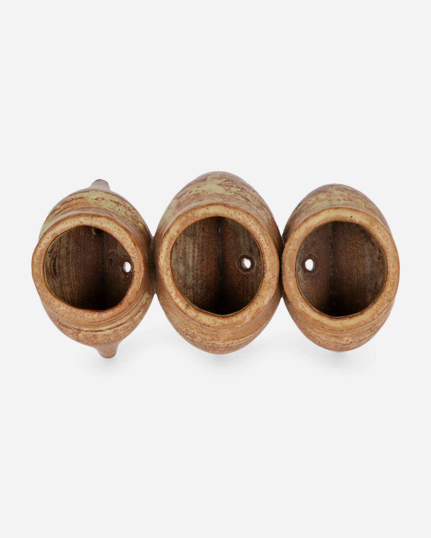 Three connected planters with pinched bottoms, drainage holes, and feet. Shown from the top.