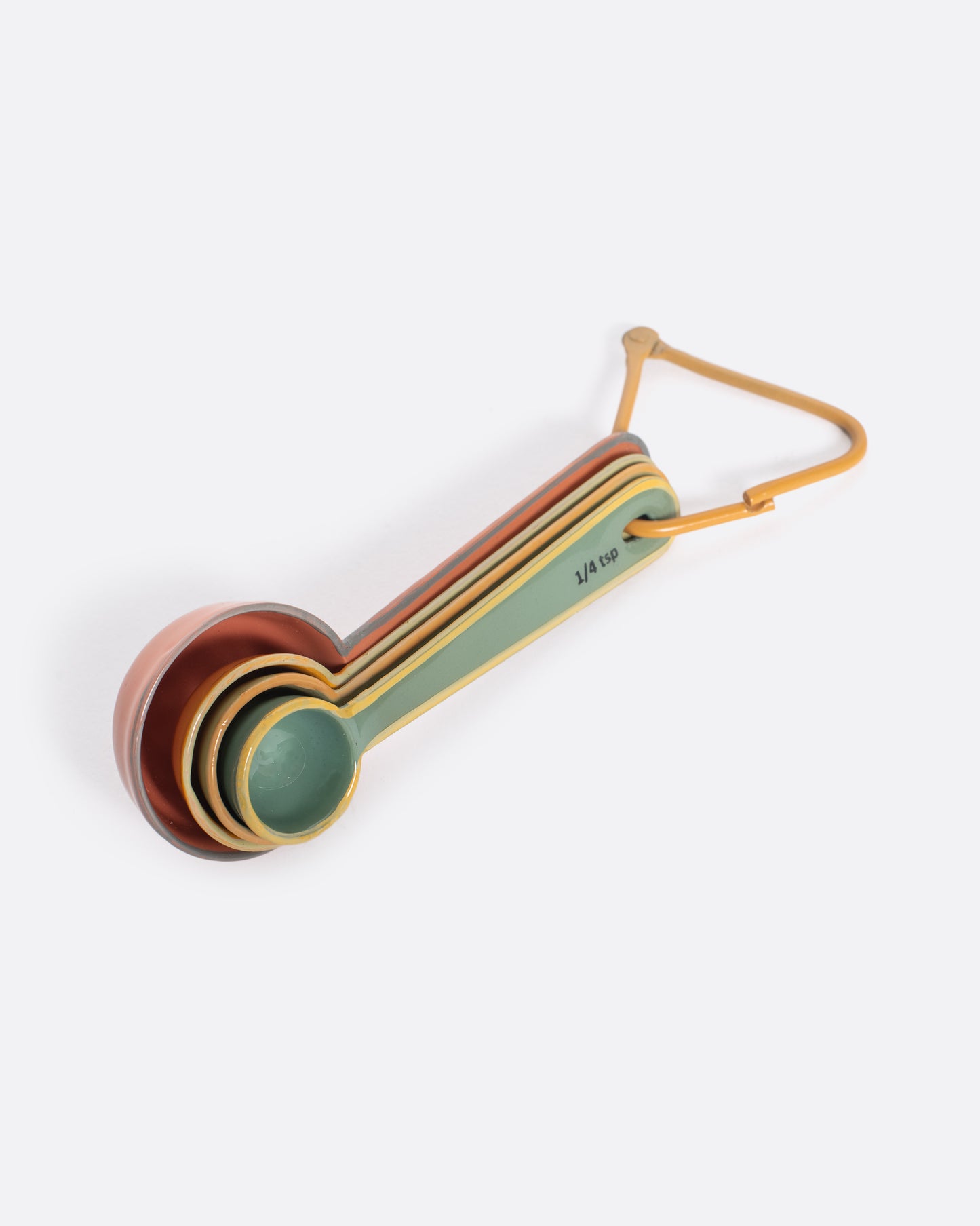 A set of four measuring spoons, each a different color, on a triangular carabiner.