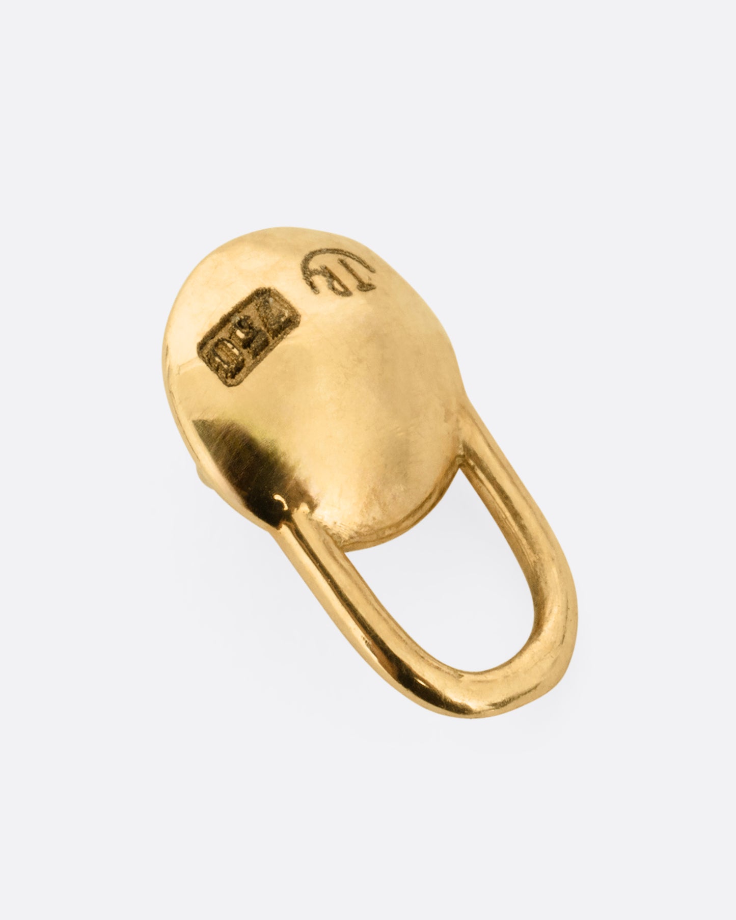 A yellow gold padlock shaped pendant with a prong set ruby cabochon. Shown from the back.