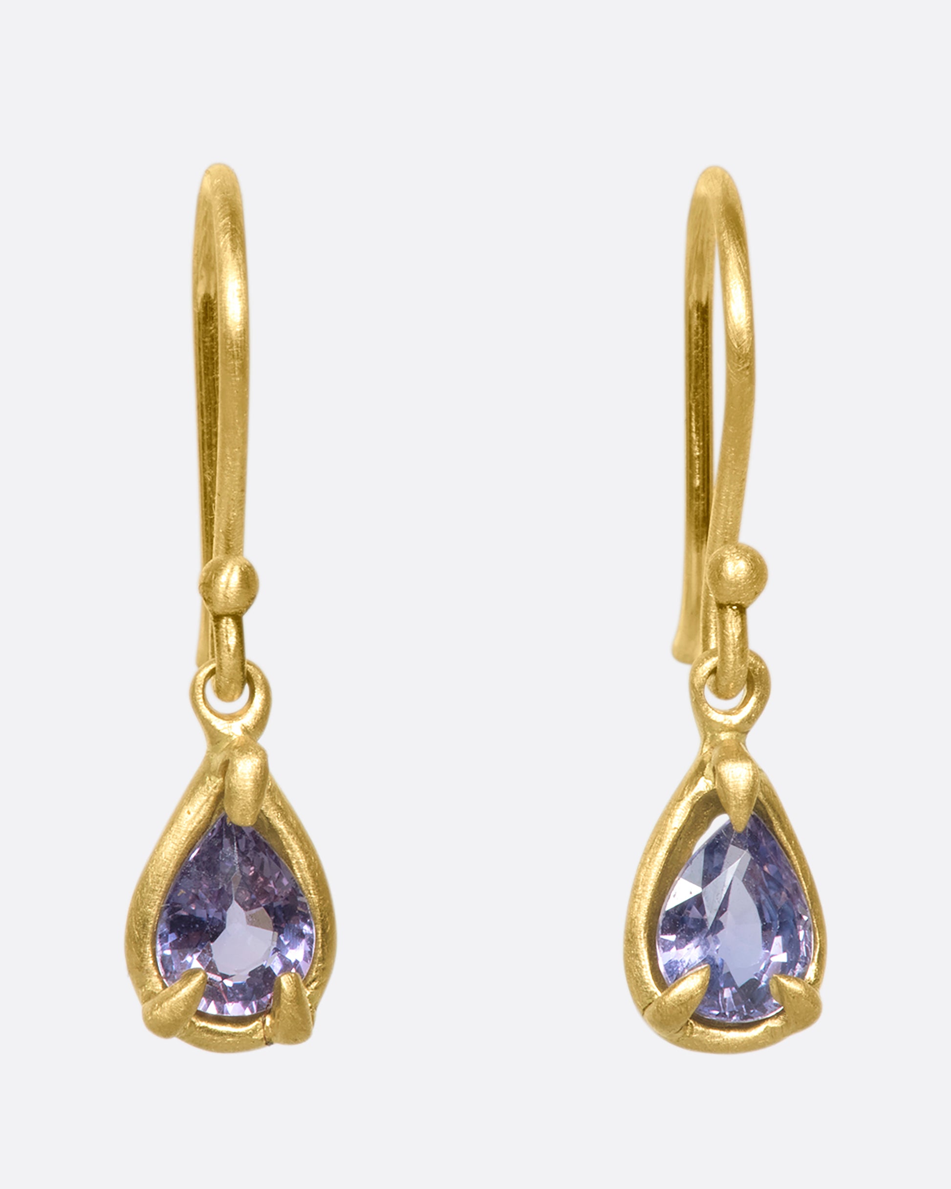 One-of-a-kind purple sapphire drops in an 18k gold pronged bezel setting