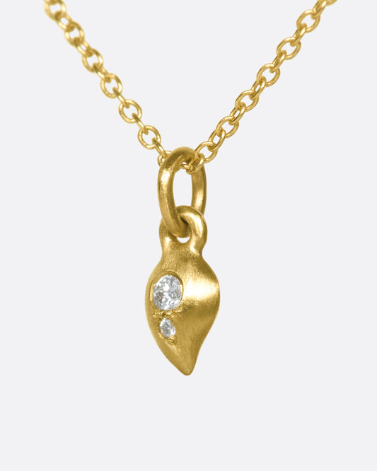 This delicate 10k gold necklace features two diamonds sparkling in a gold droplet