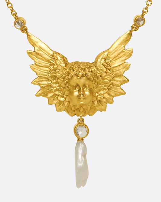 A show-stopping 18k gold cherub necklace with three bezel-set rose-cut white diamonds and a natural pearl drop