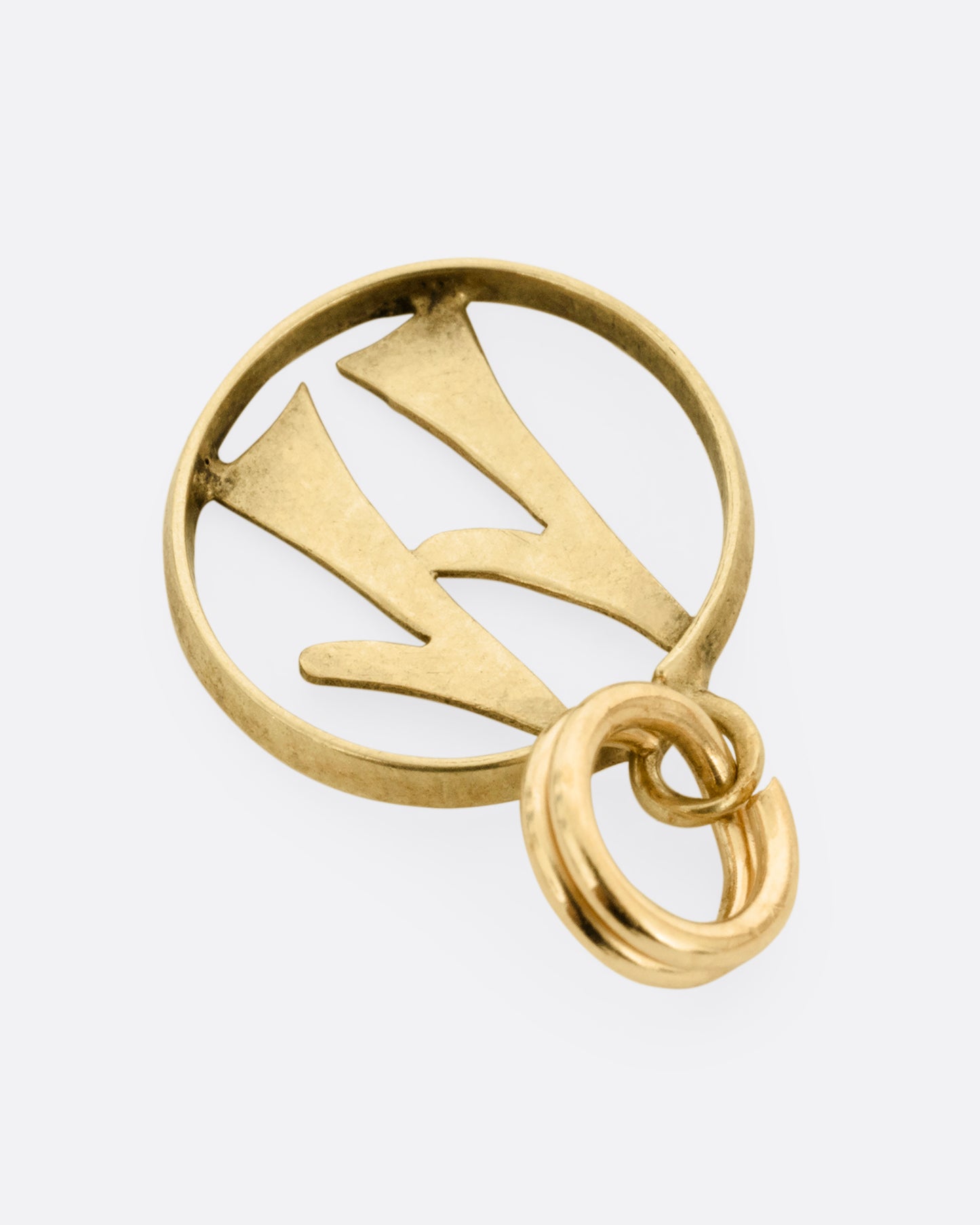 An open round yellow gold '11' pendant, shown from the back.