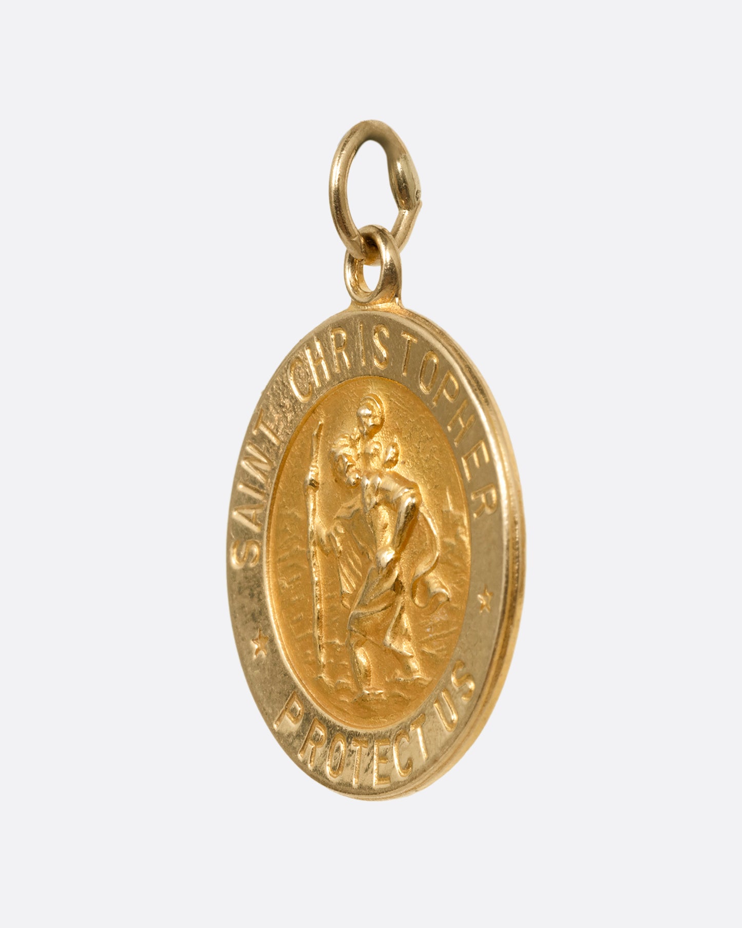 A round yellow gold Saint Christopher pendant, shown from the side.